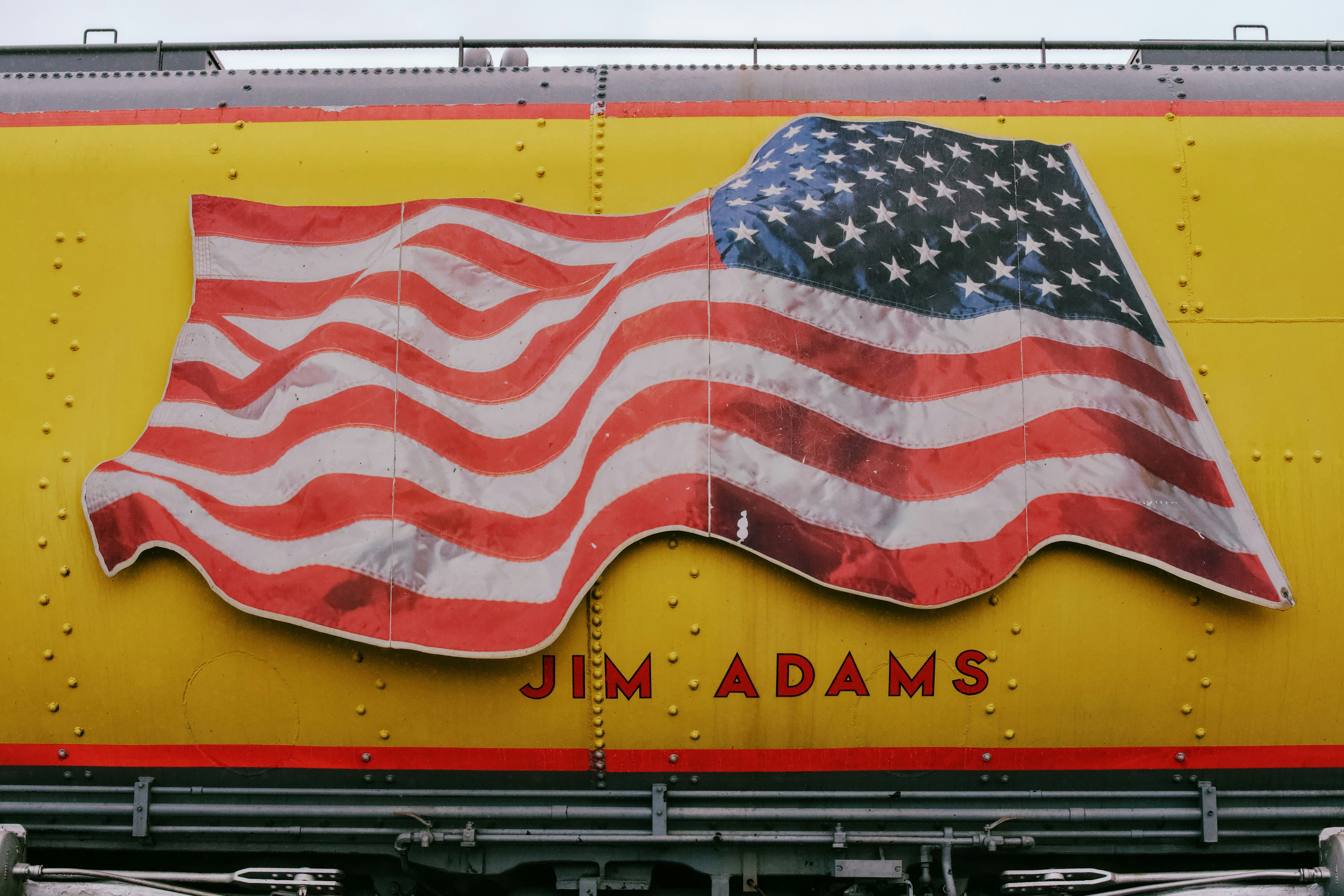 American flag painted on a yellow train car