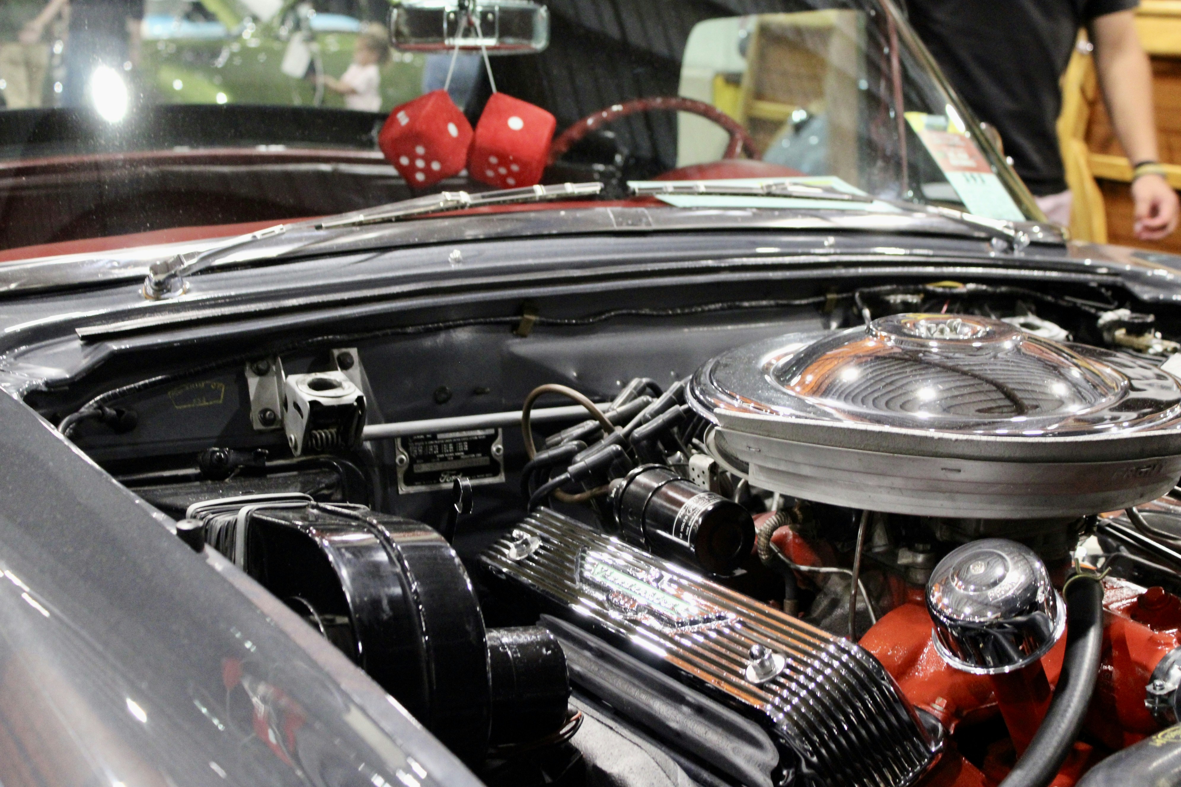 Classic car engine with fuzzy dice hanging