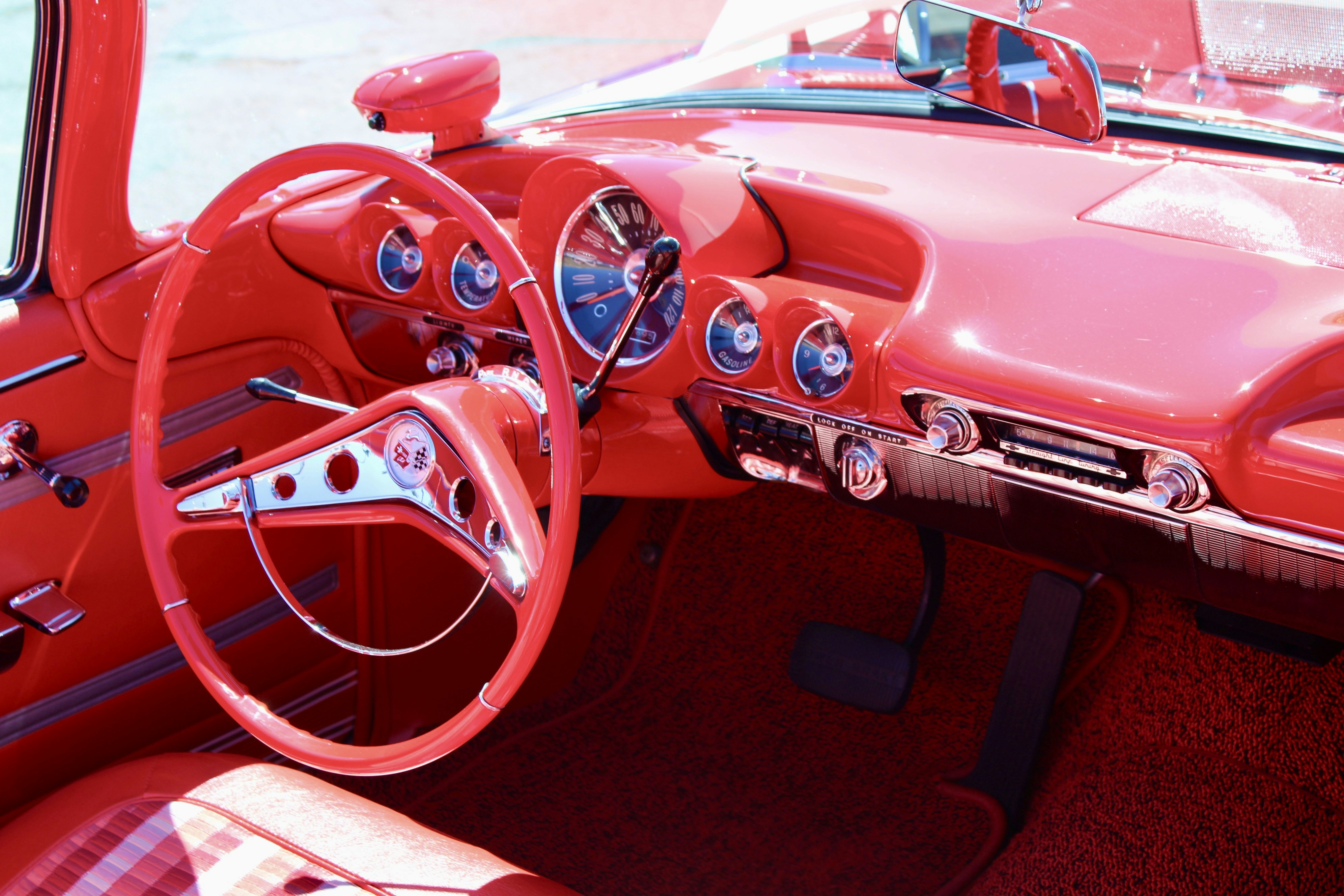 Red vintage car interior with dashboard and steering wheel