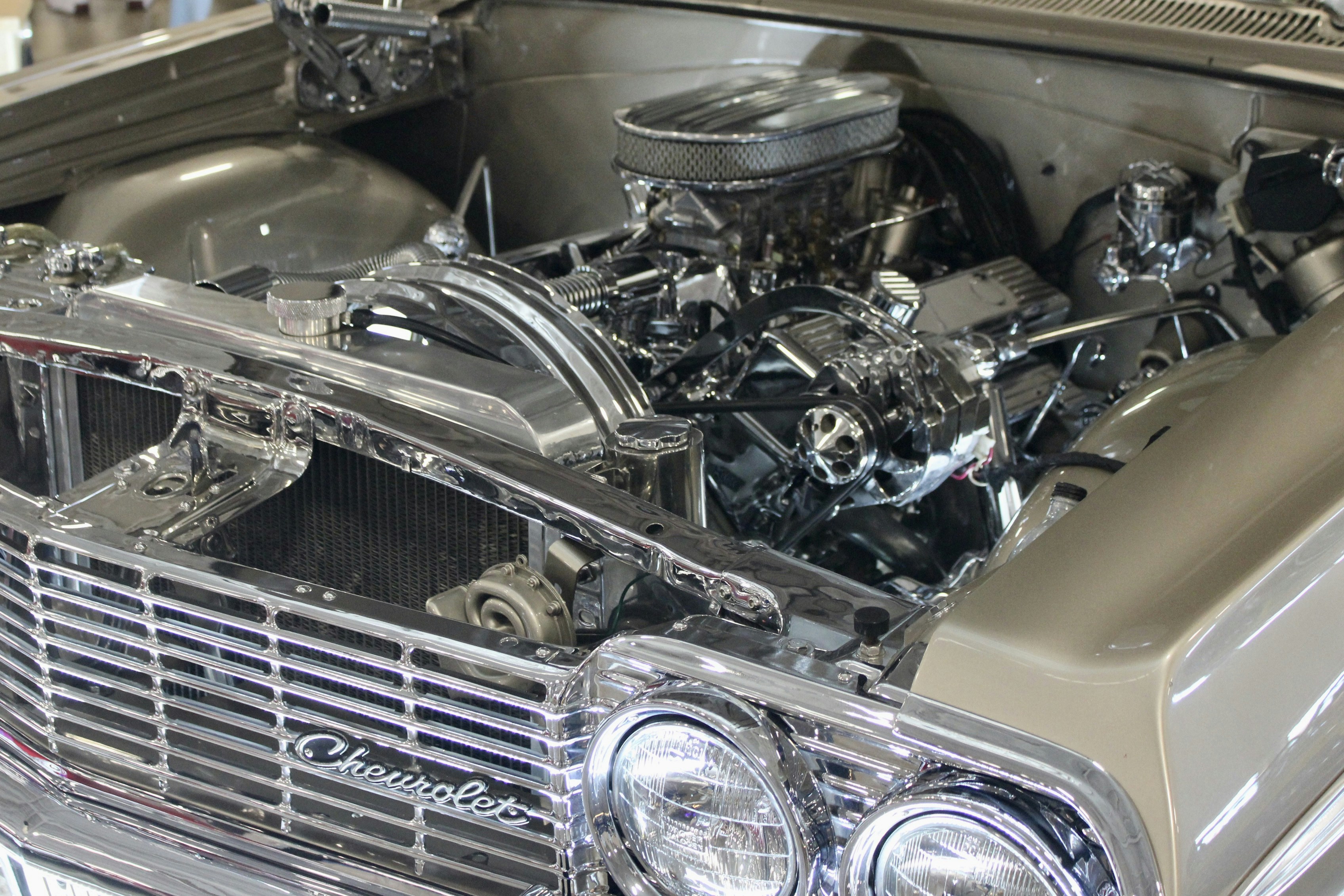 Chrome engine and grille of a classic chevrolet car.