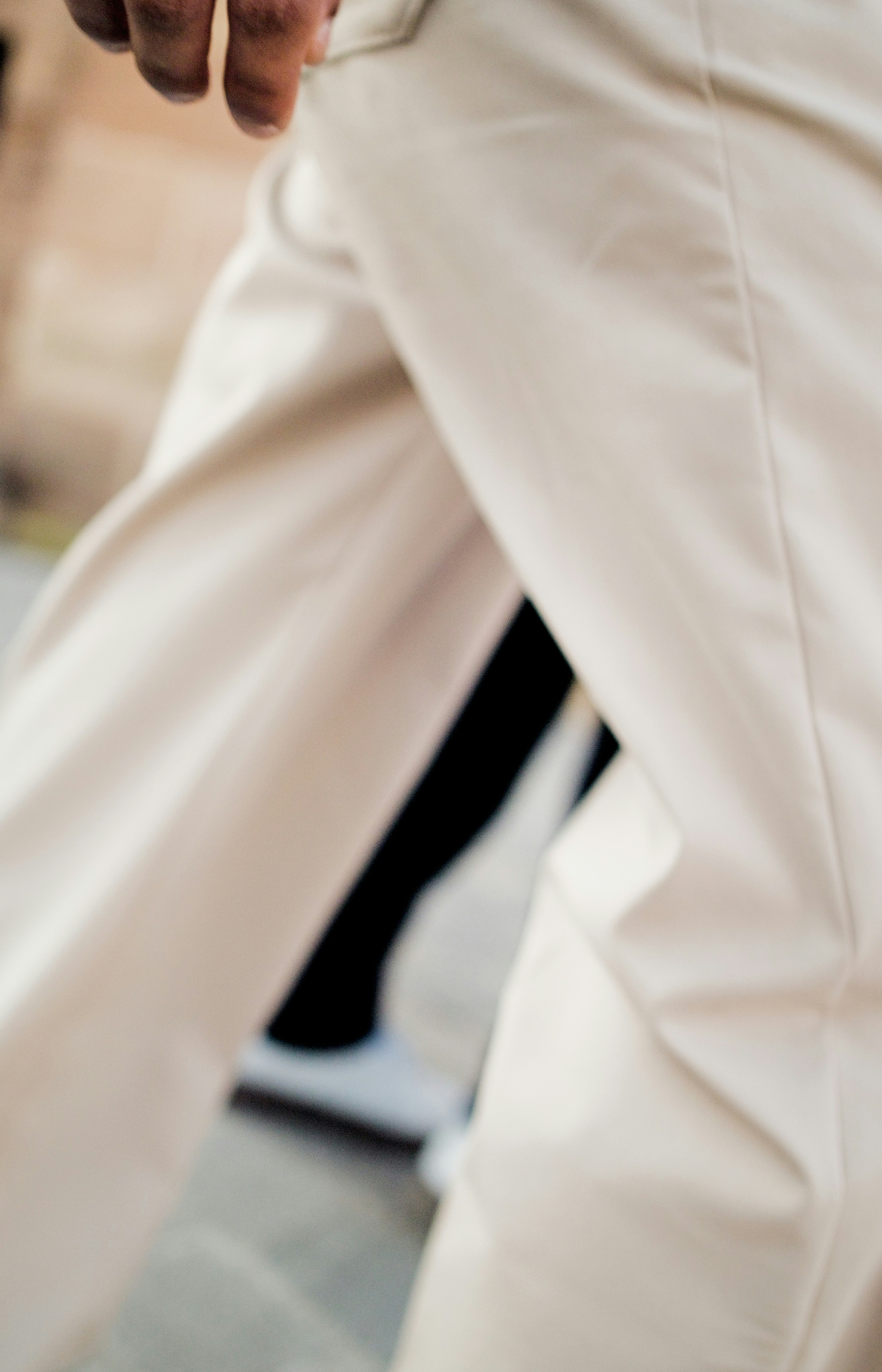 A person wearing light-colored pants and white sneakers.