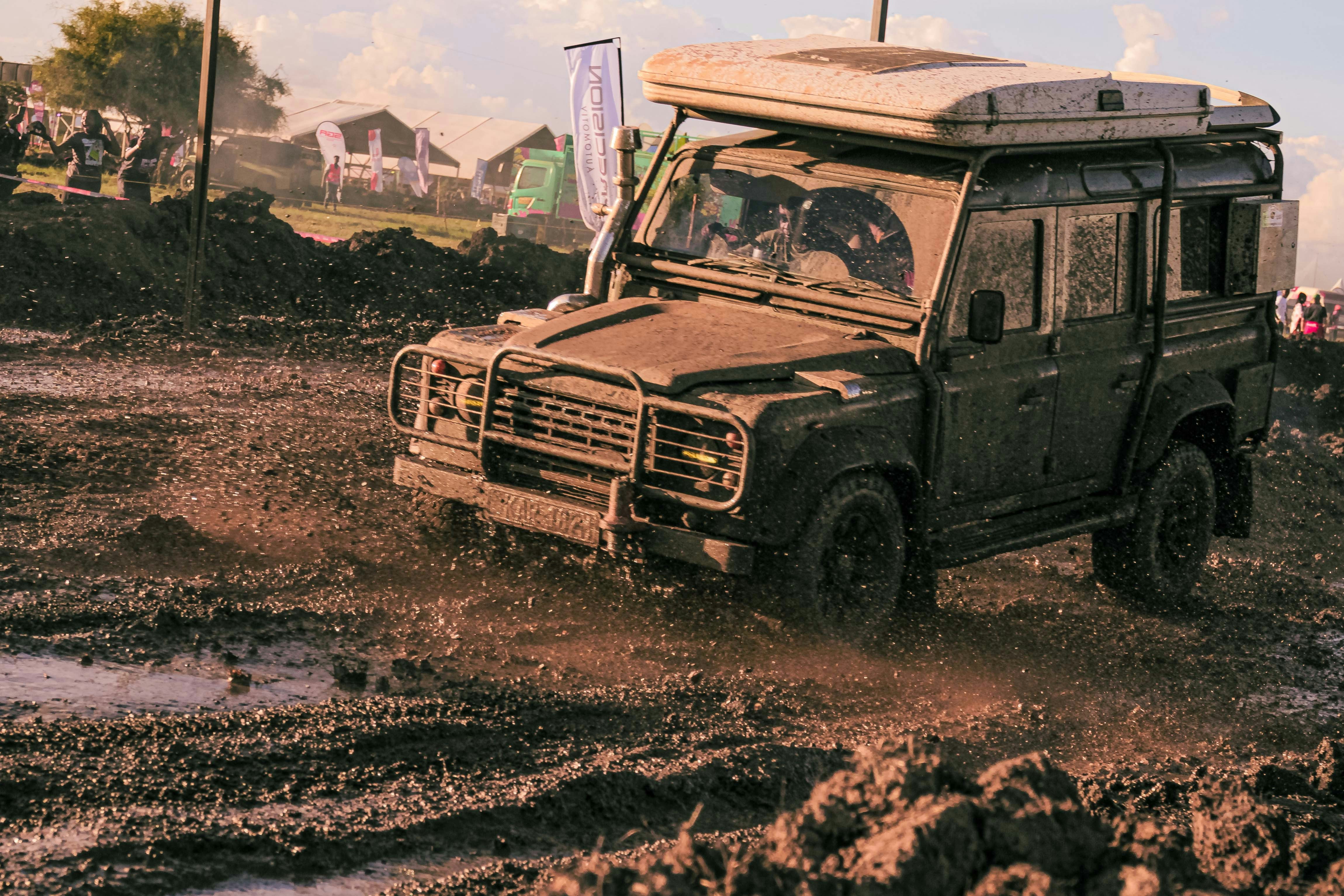Off-road vehicle driving through mud and dirt