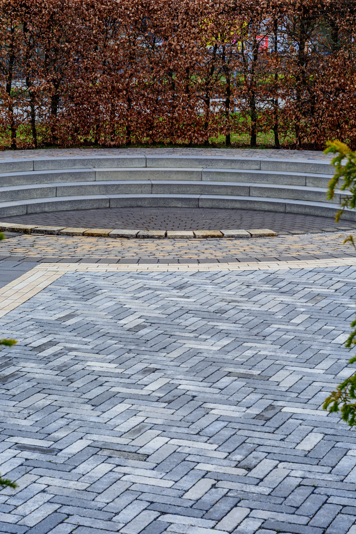 Curved stone steps lead to a central circular area