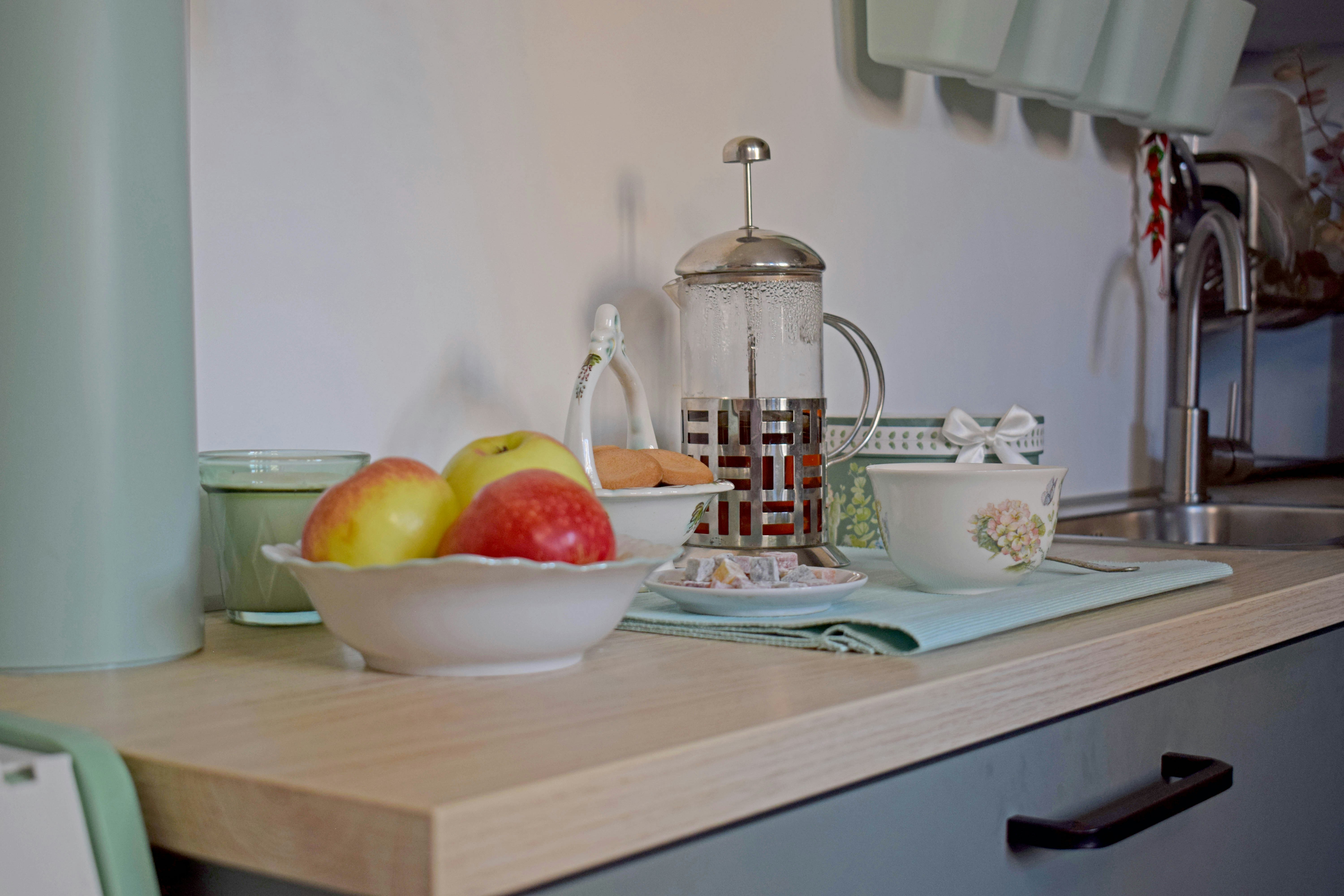 Apples in bowl with coffee press and cup