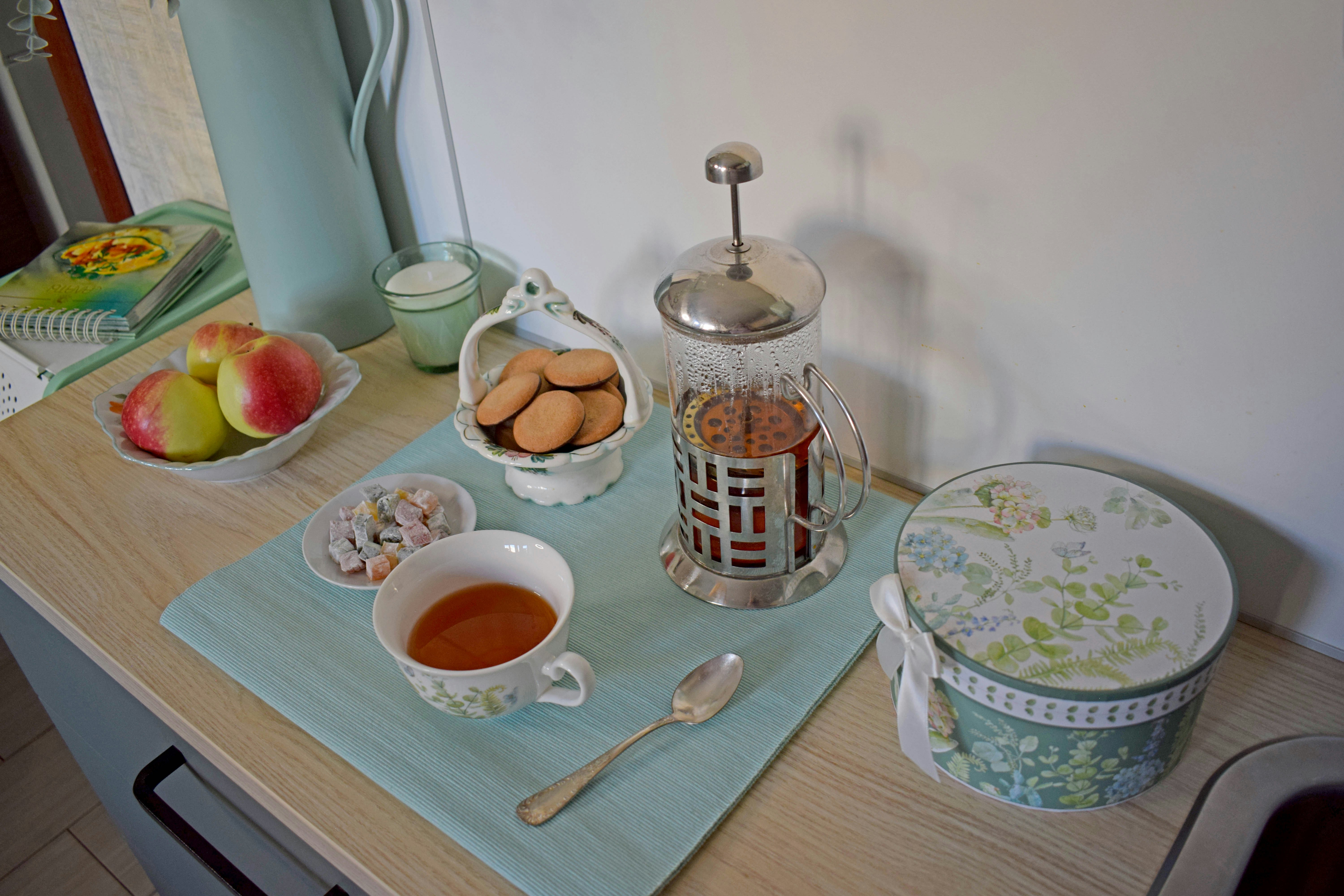 Tea service with cookies, fruit, and a french press