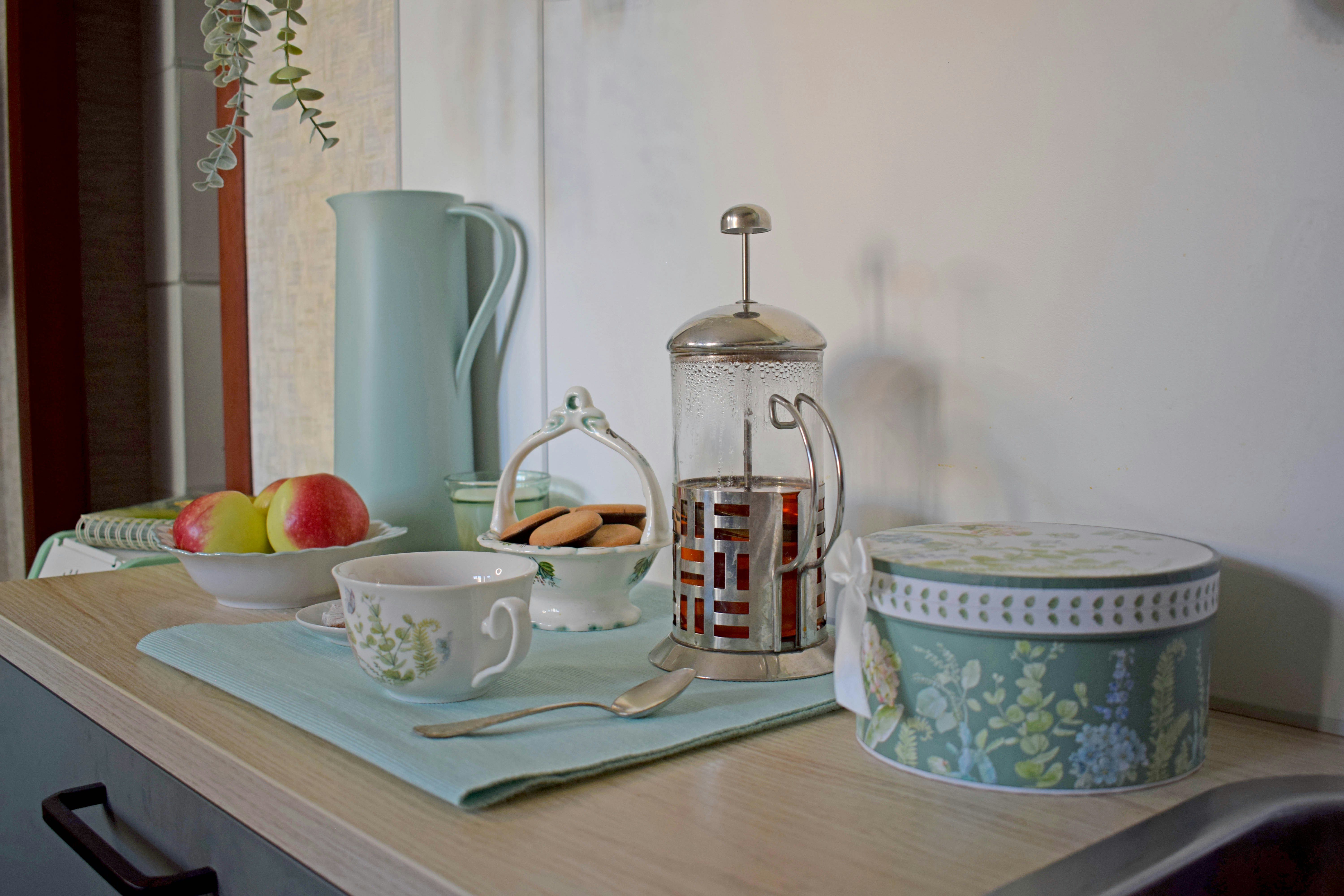 Tea set with cookies, fruit, and a french press