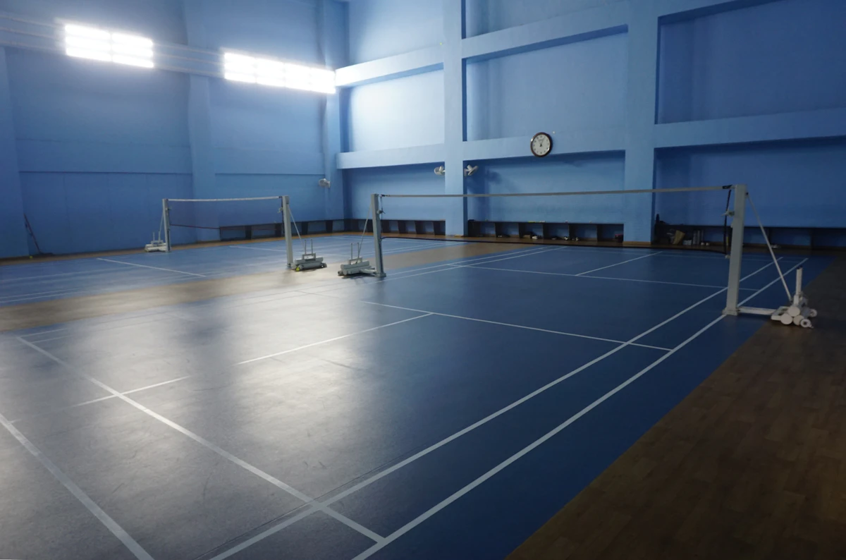 Indoor badminton courts with blue flooring
