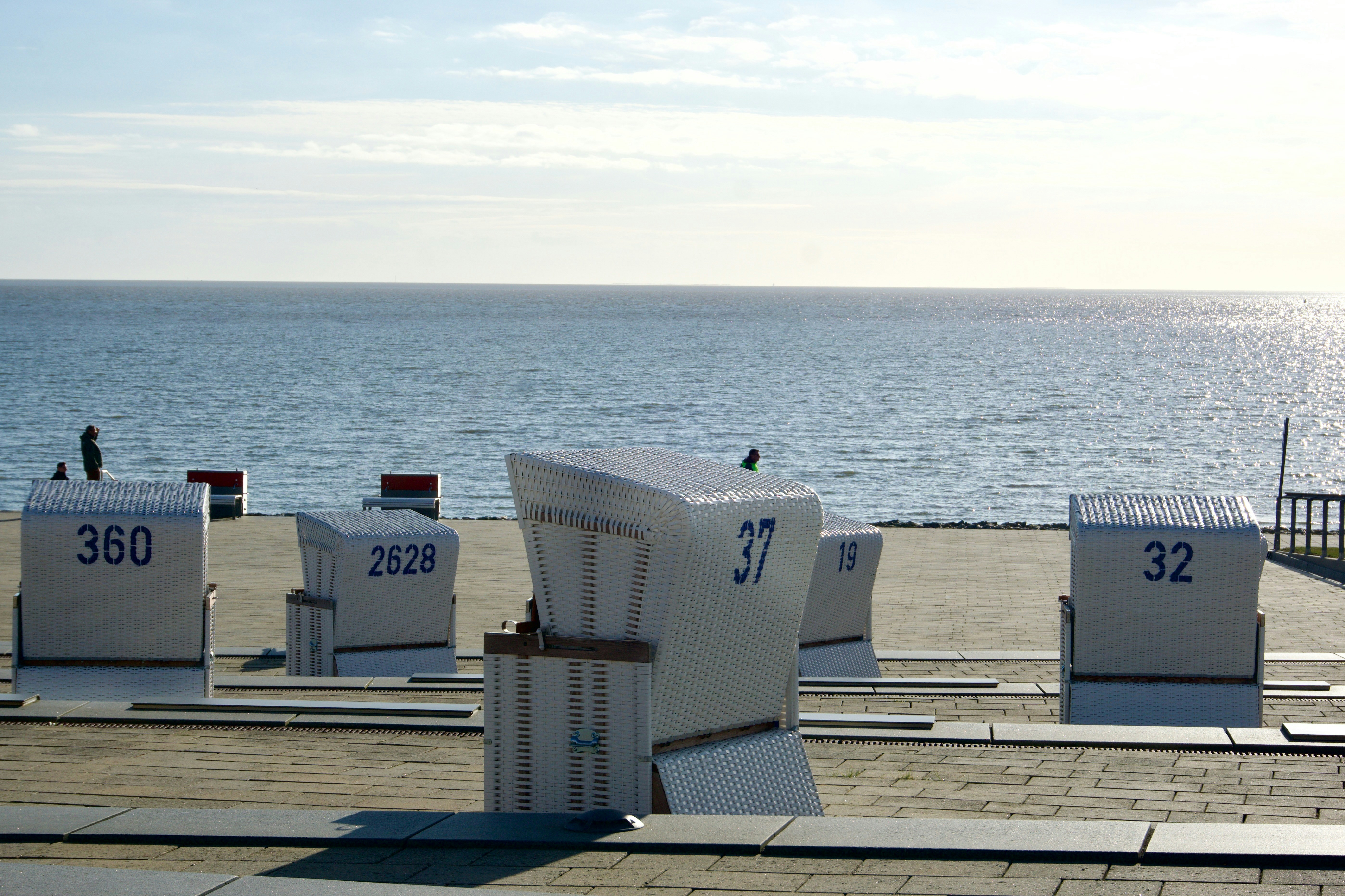 Beach chairs on a promenade overlooking the ocean