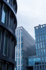 Modern office buildings with geometric facades under a cloudy sky