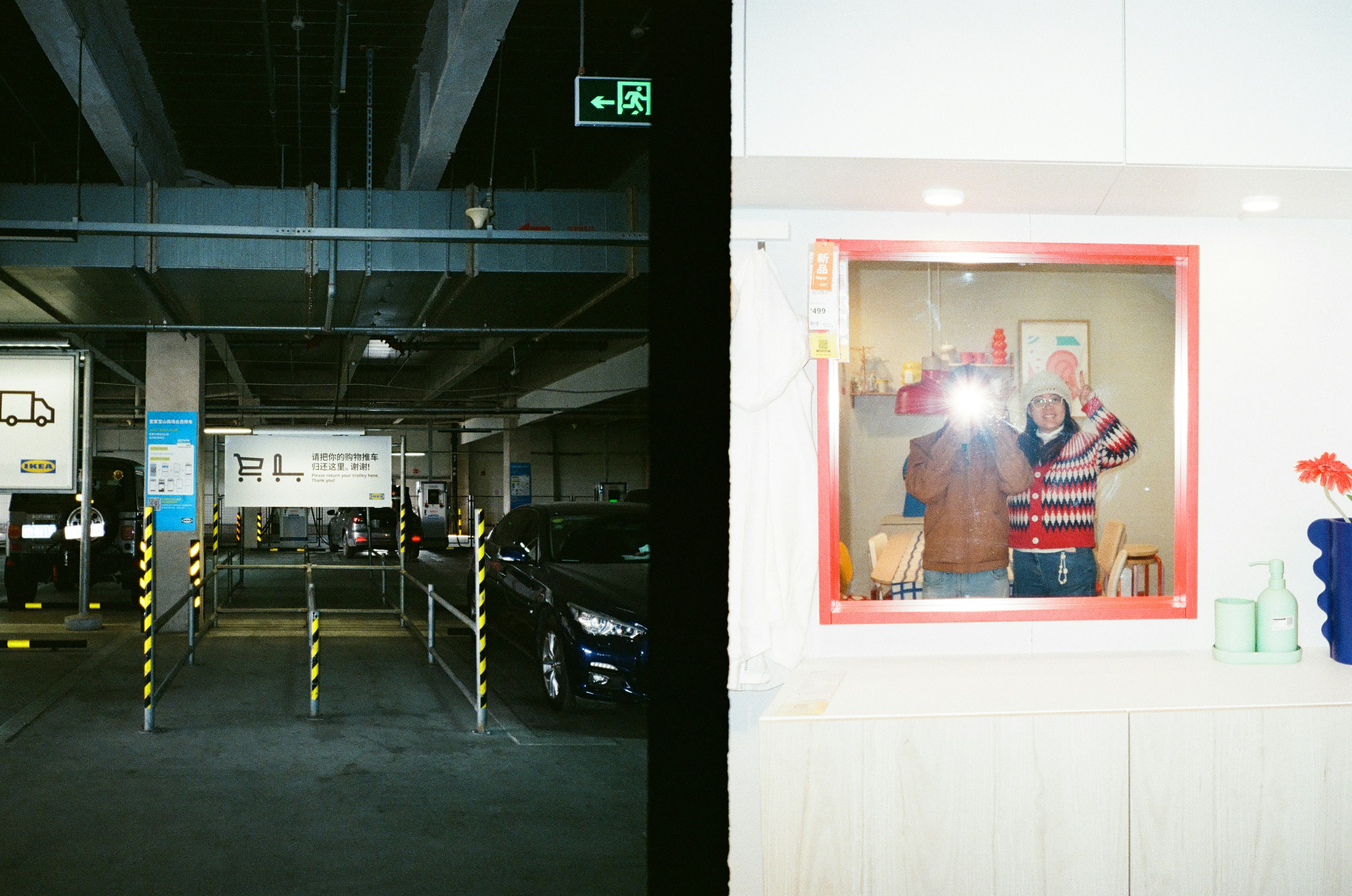 Two people taking a selfie in a mirror.