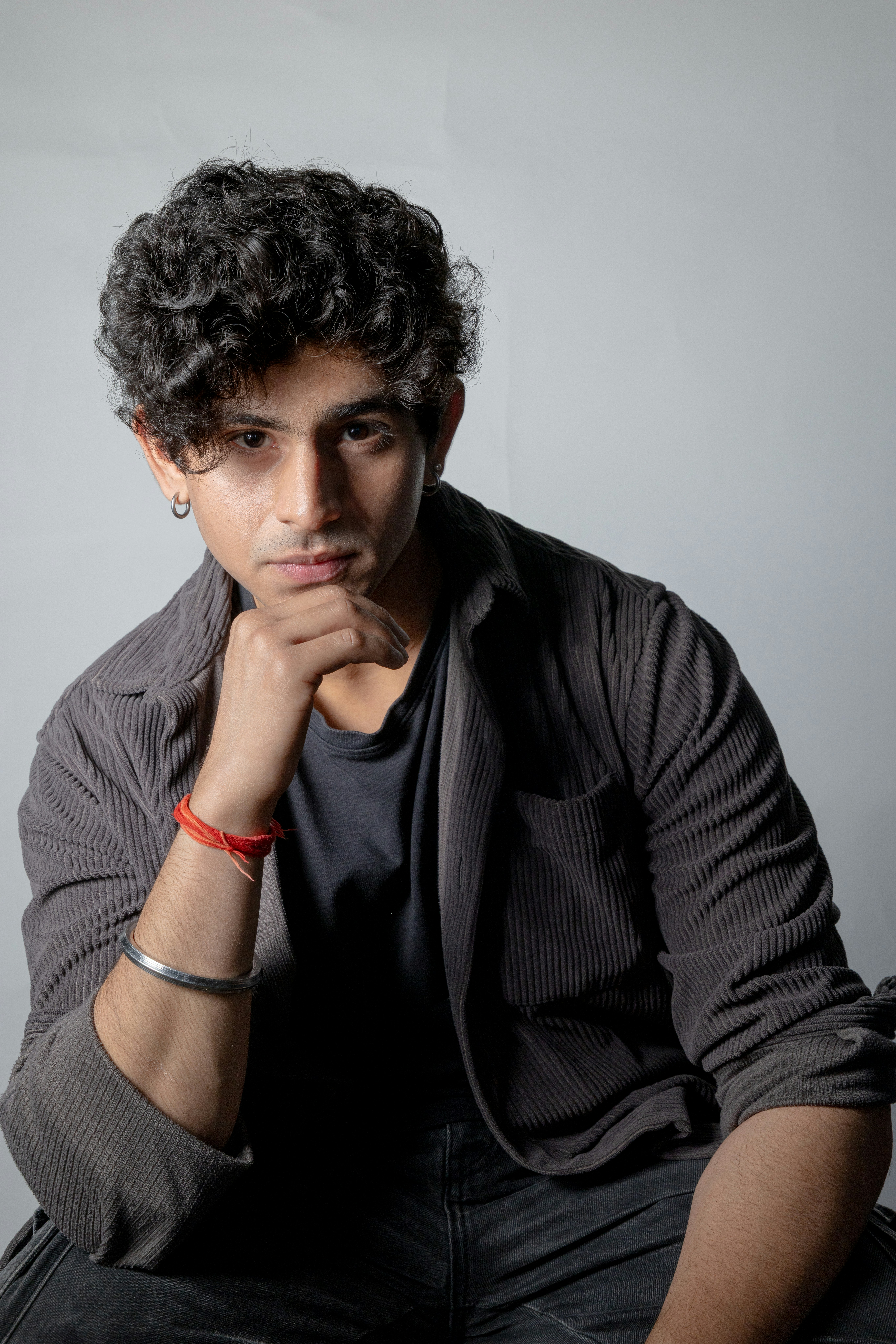 Man with curly hair wearing a jacket