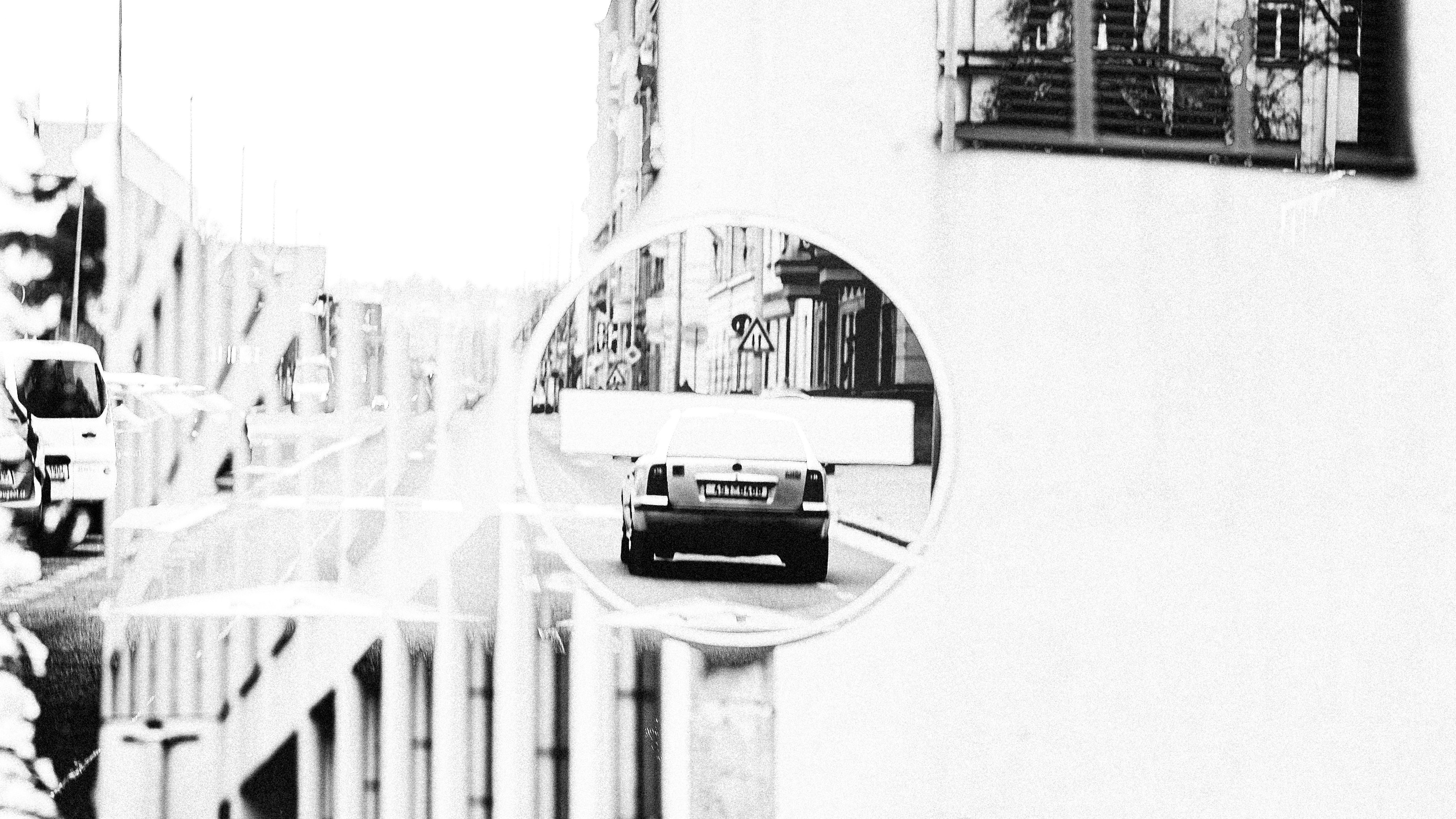 Car driving down a city street through a circle.