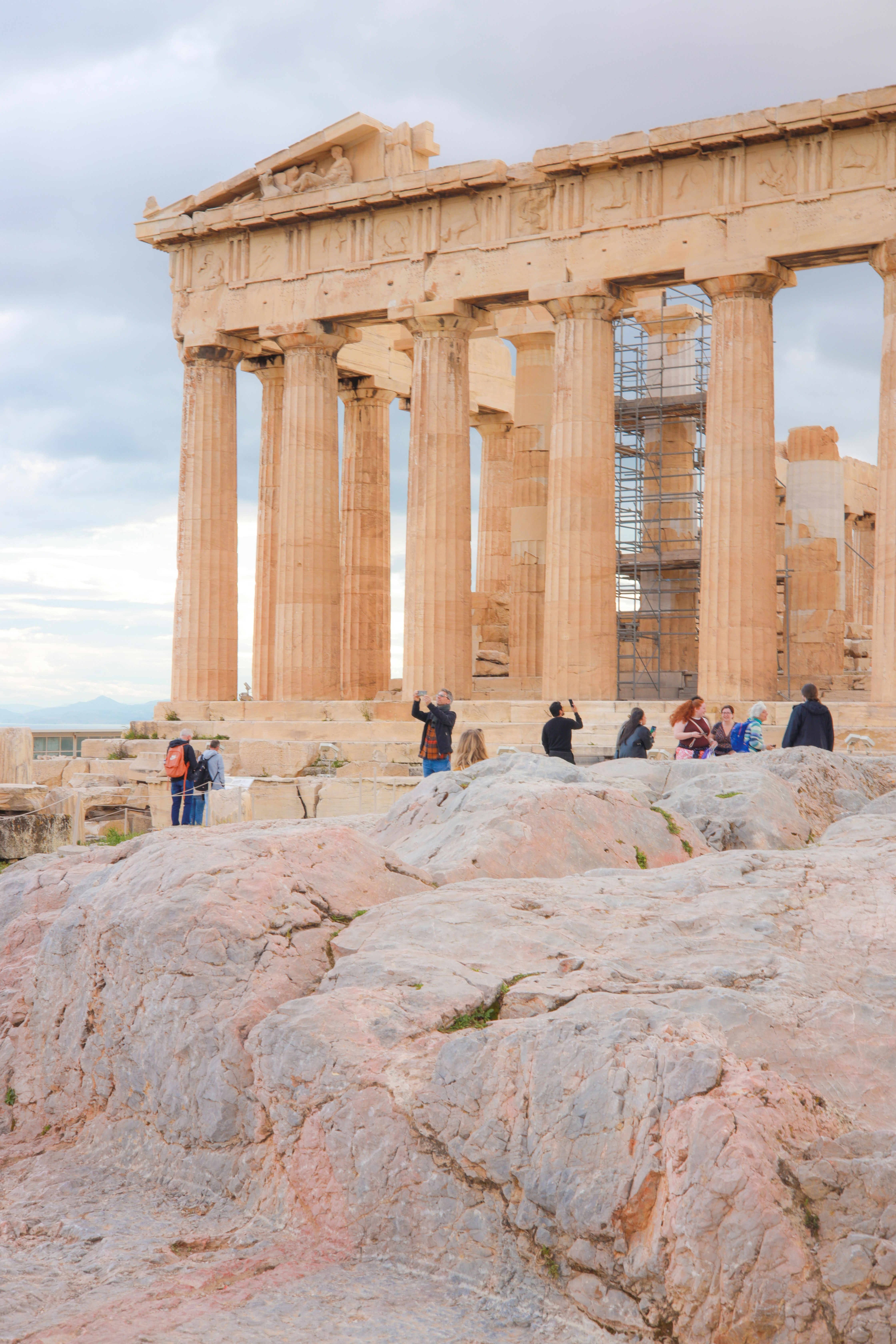 Tourists photograph the ancient parthenon in athens, greece.