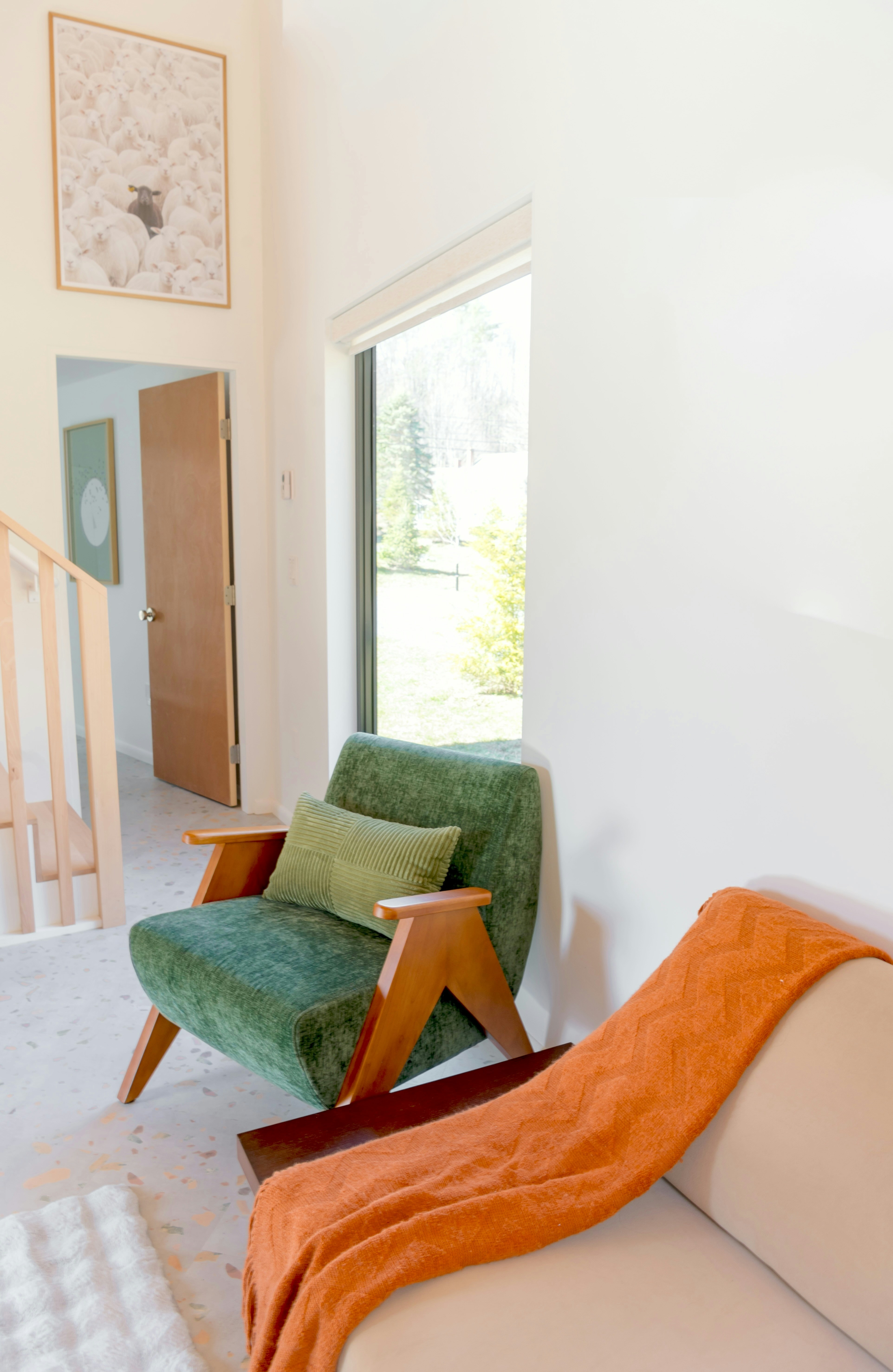 Green armchair with orange blanket on sofa