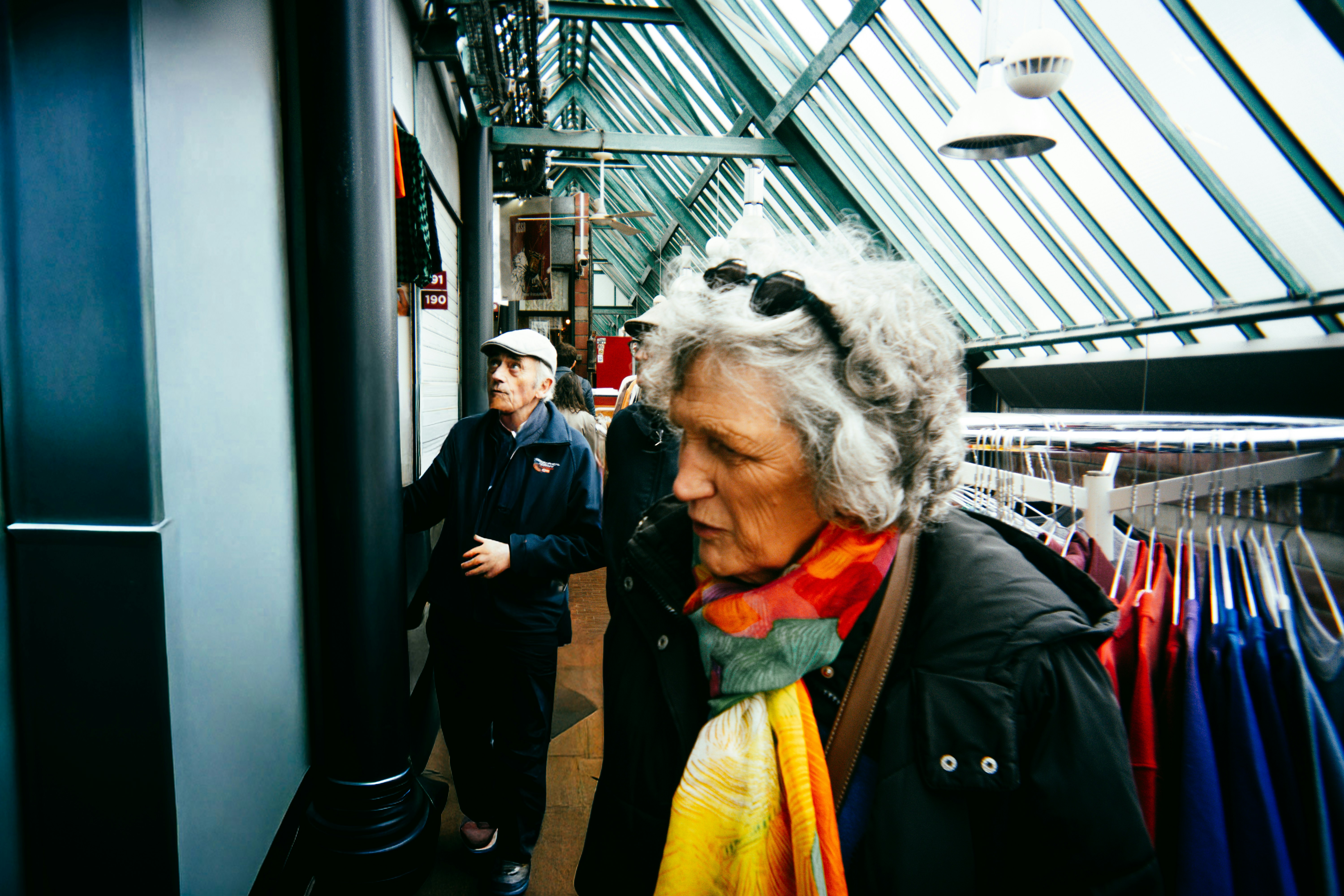 elderly woman with a colorful scarf in an indoor market