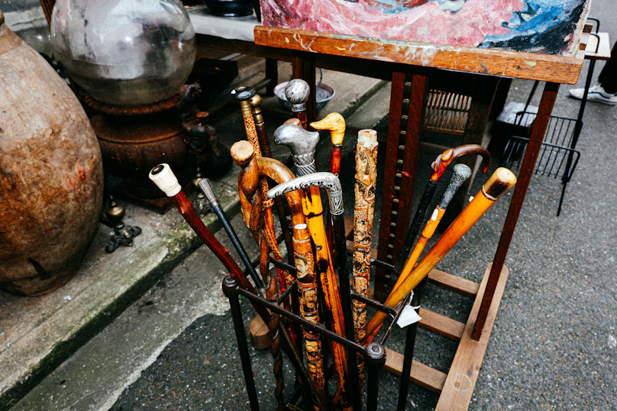 Antique walking sticks with carved handles gathered in a stand