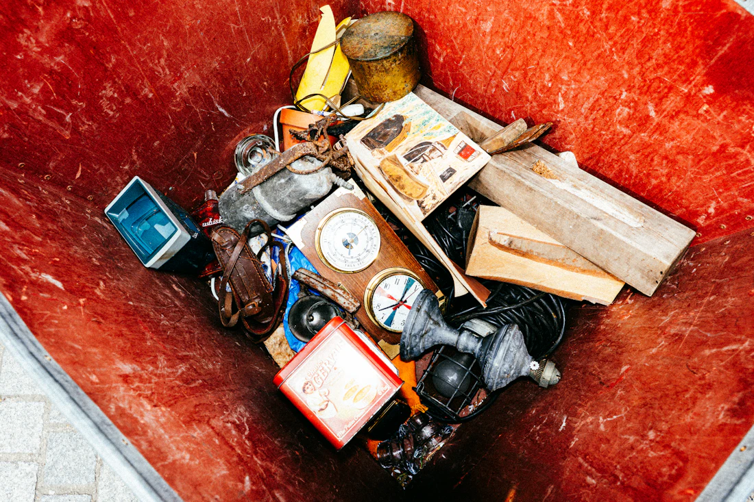 Bin overflowing with discarded household clutter