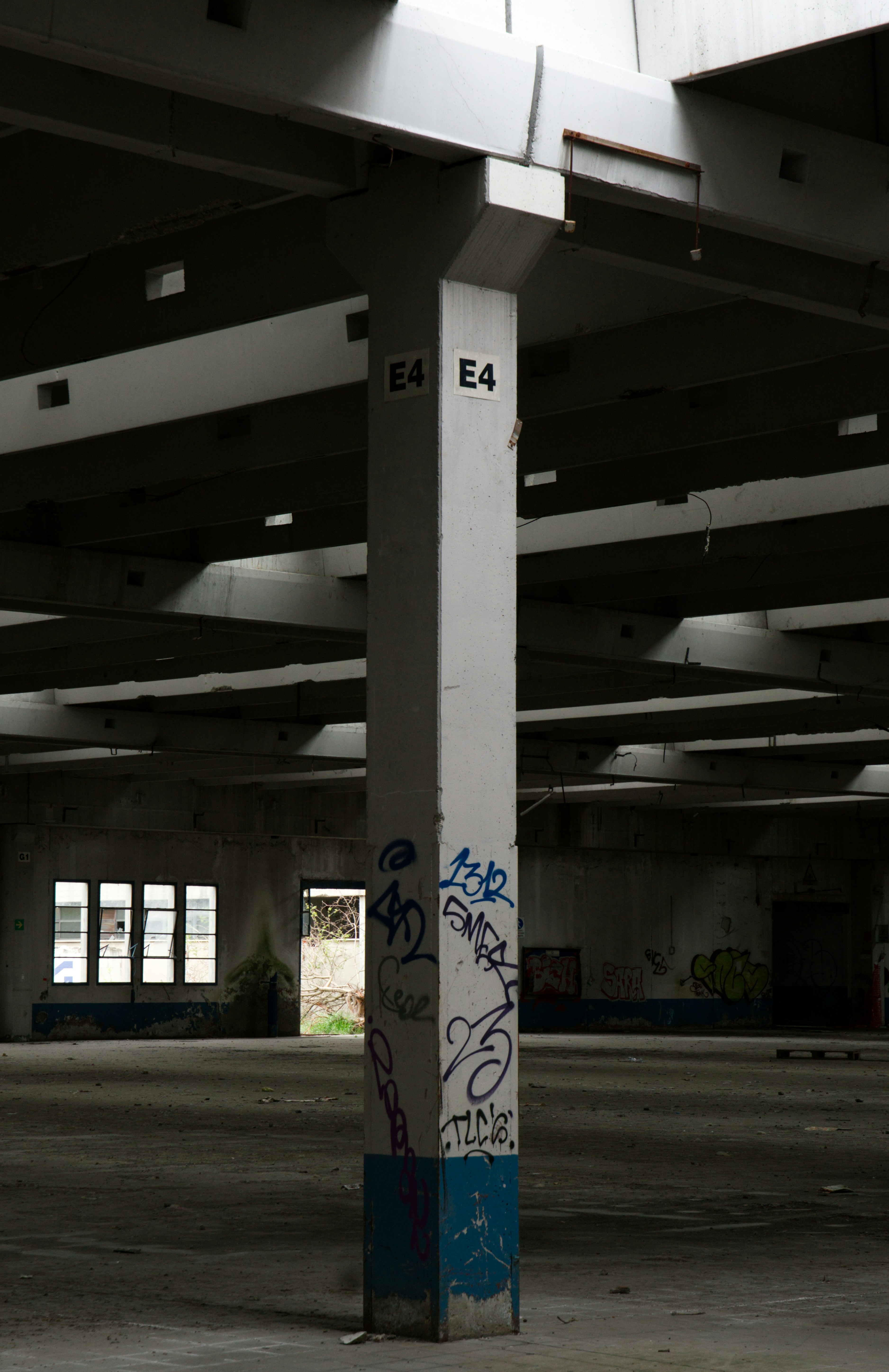 Graffiti-covered pillar in abandoned industrial building