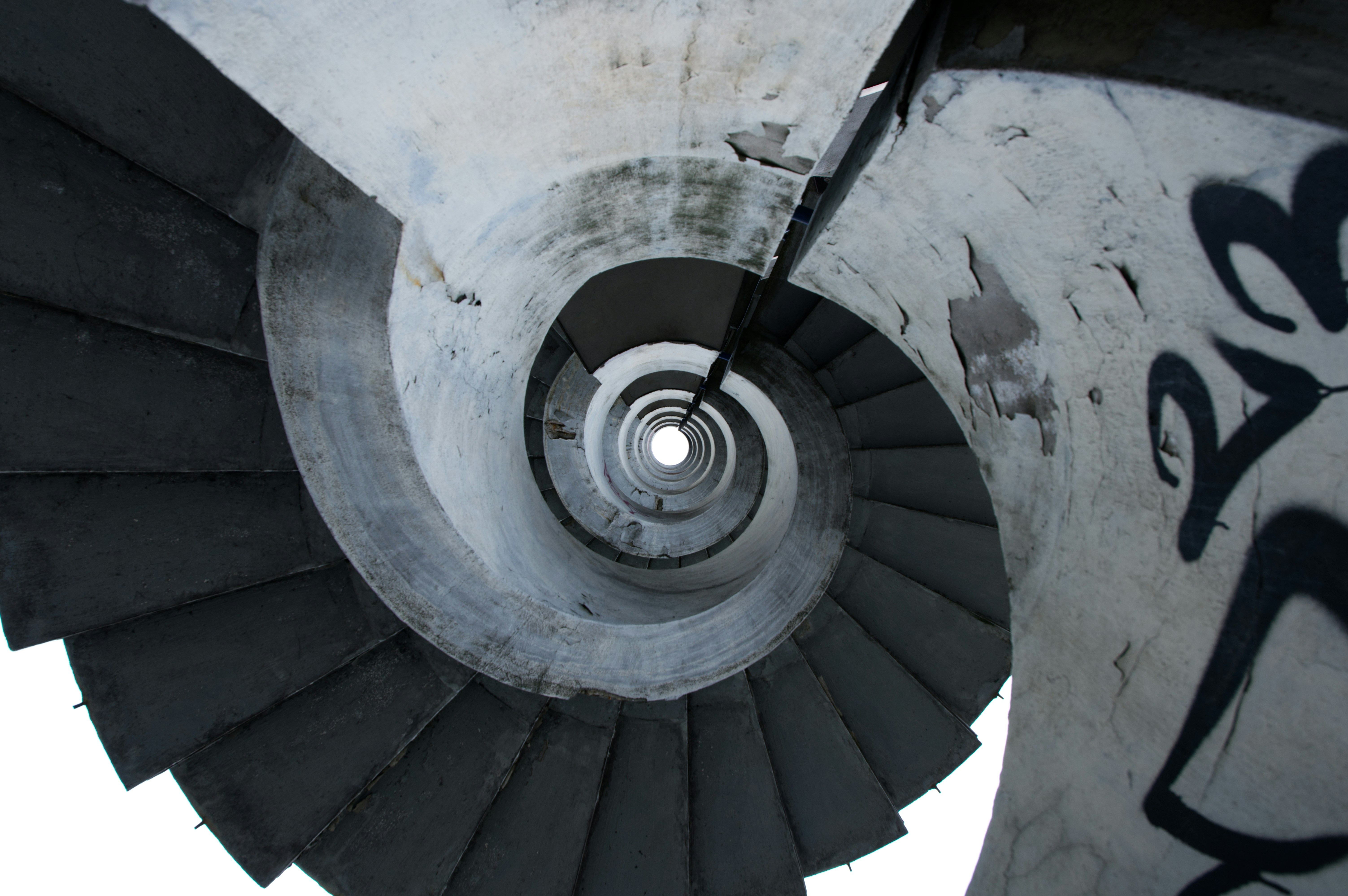 Concrete spiral staircase with graffiti