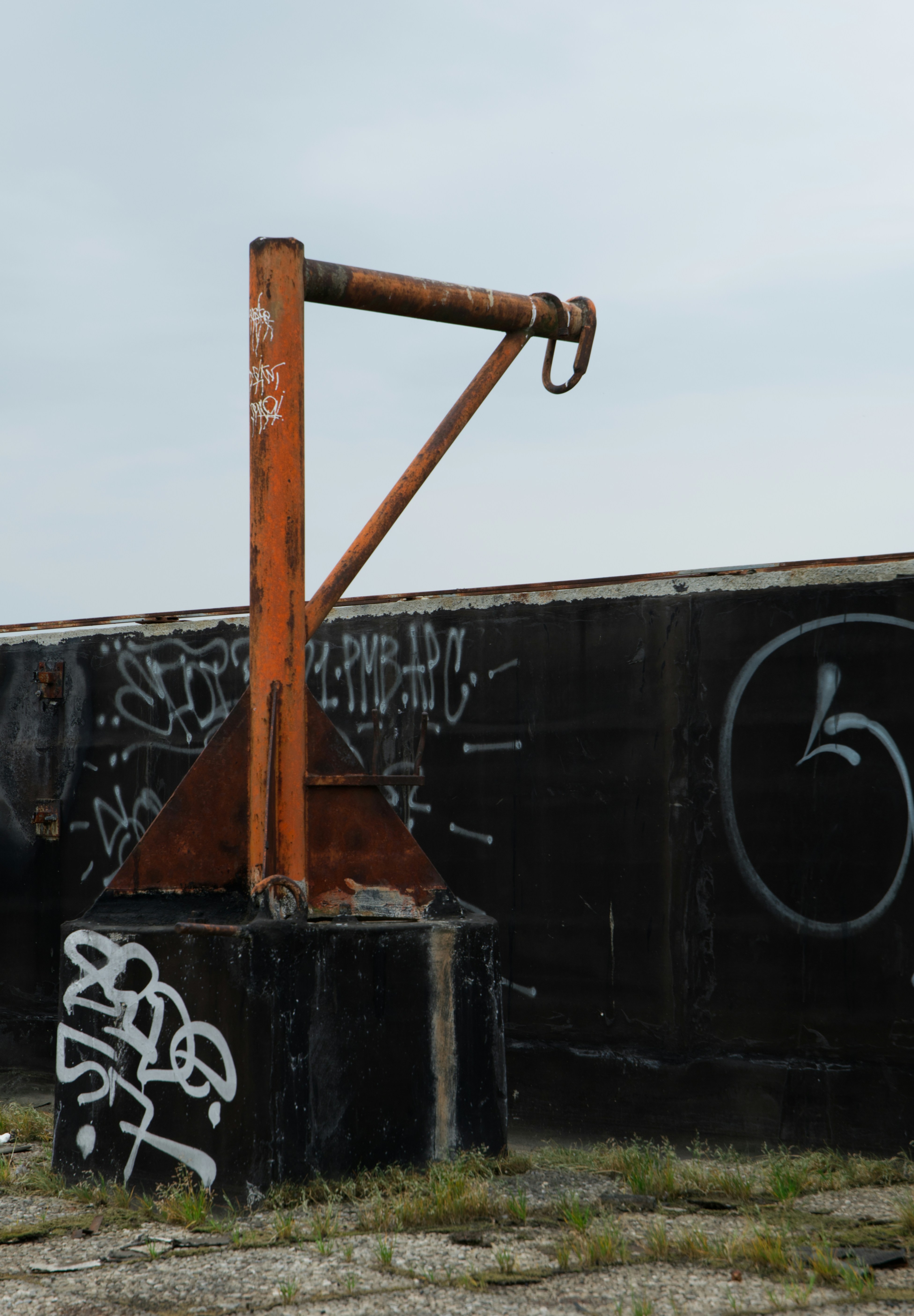Rusty metal structure with graffiti on a cloudy day