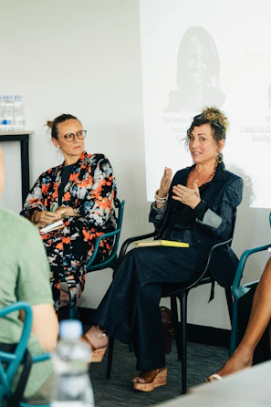 Two women speaking on a panel discussion