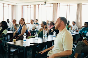 Diverse group of people attending a presentation in-person conference