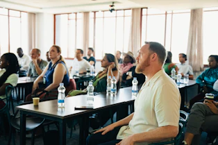 Diverse group of people attending a presentation in-person conference