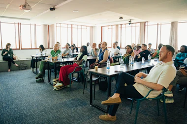 Audience attentively listening during a presentation in-person conference presentation.