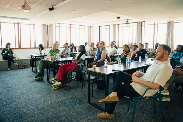 An audience listening at a bright training session