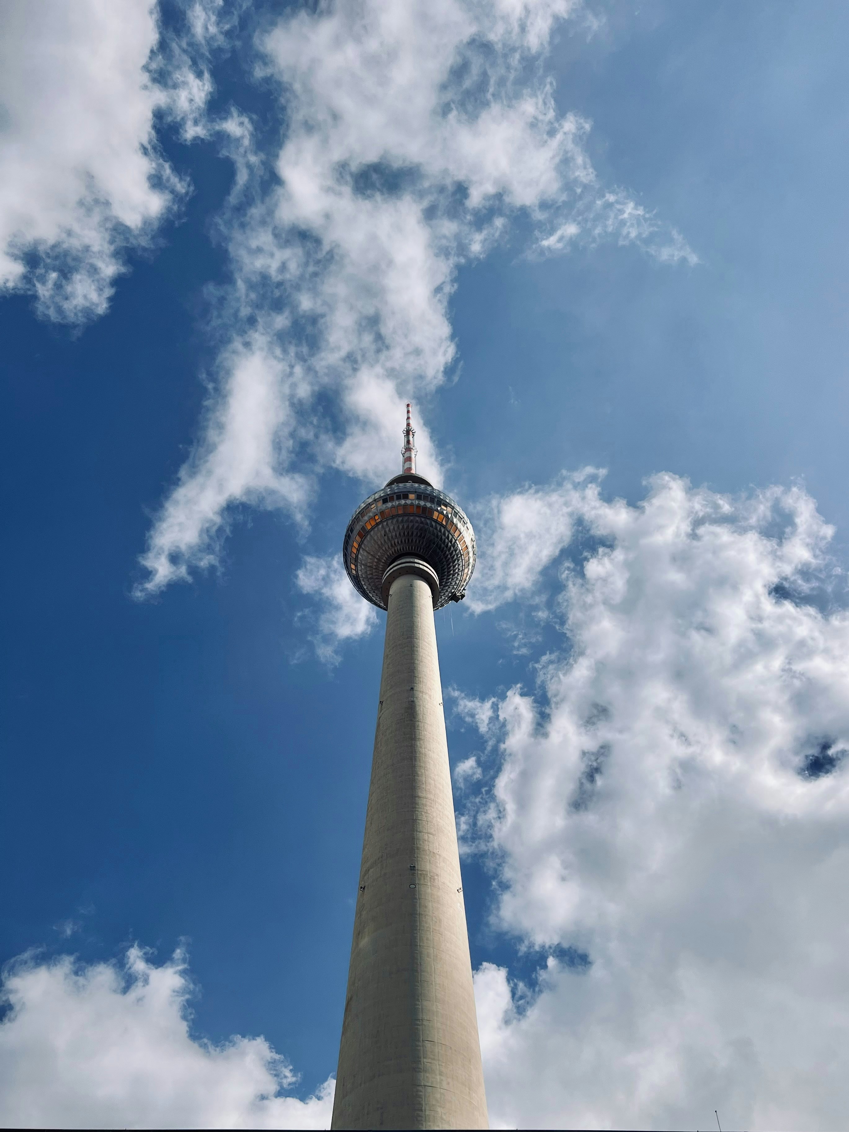 Tall concrete tower against a cloudy blue sky
