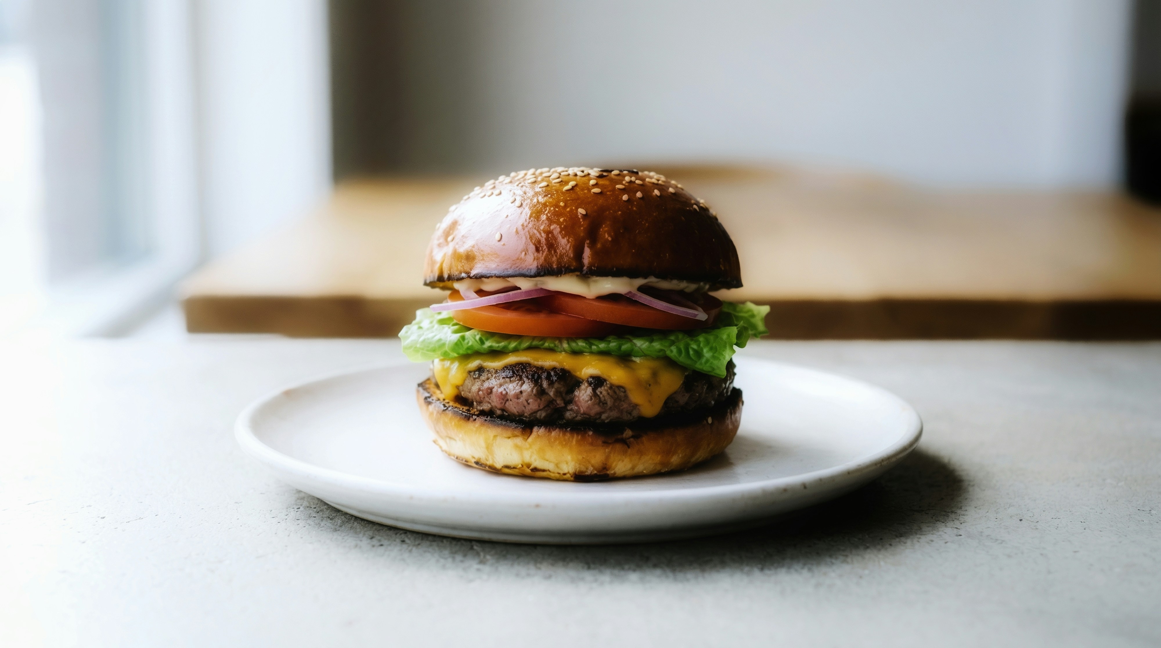 Juicy cheeseburger with lettuce and tomato on plate