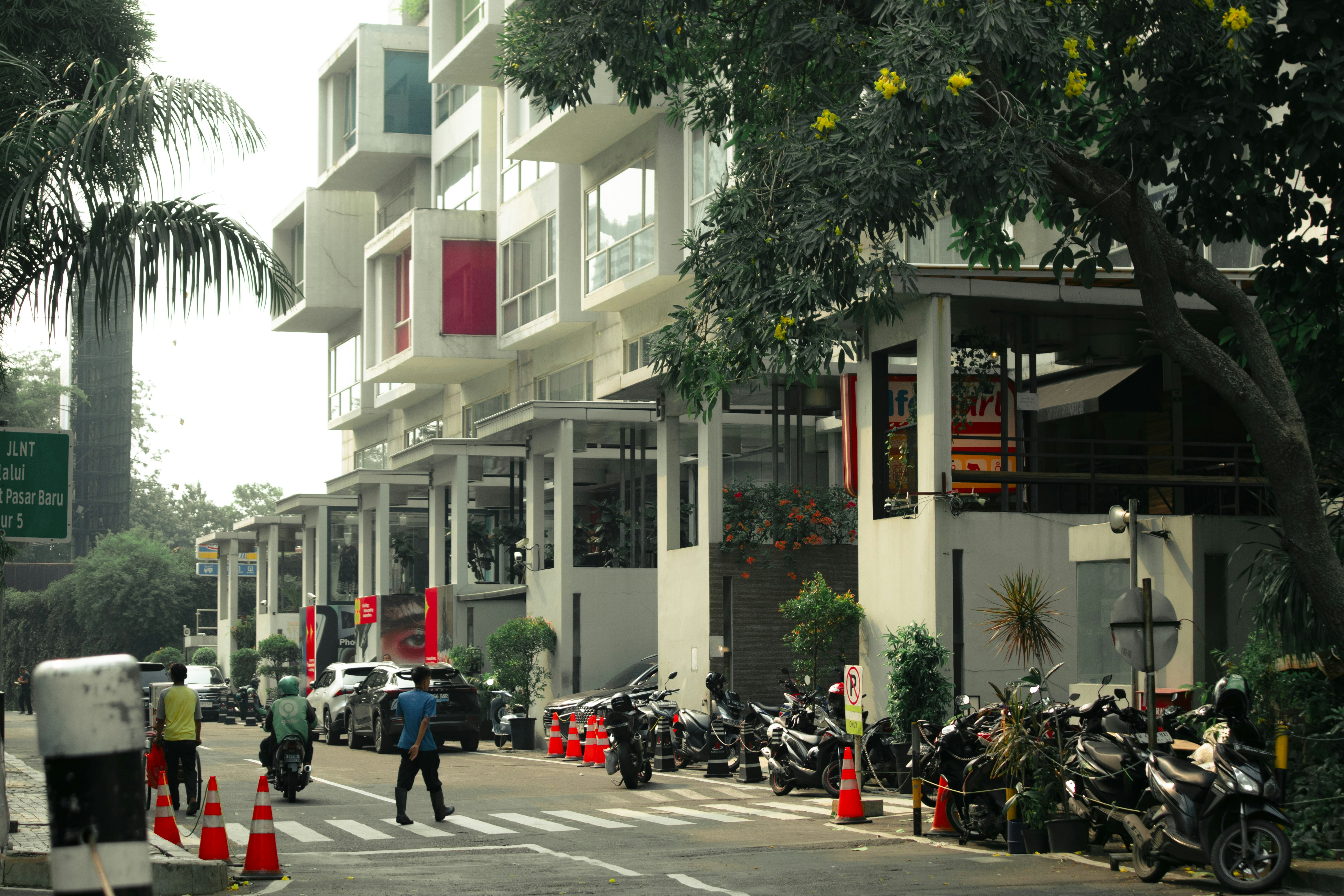 Modern building with parked motorcycles and pedestrians