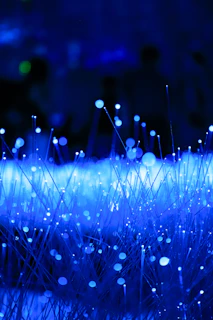 Abstract blue glowing fiber optics with bokeh effect.