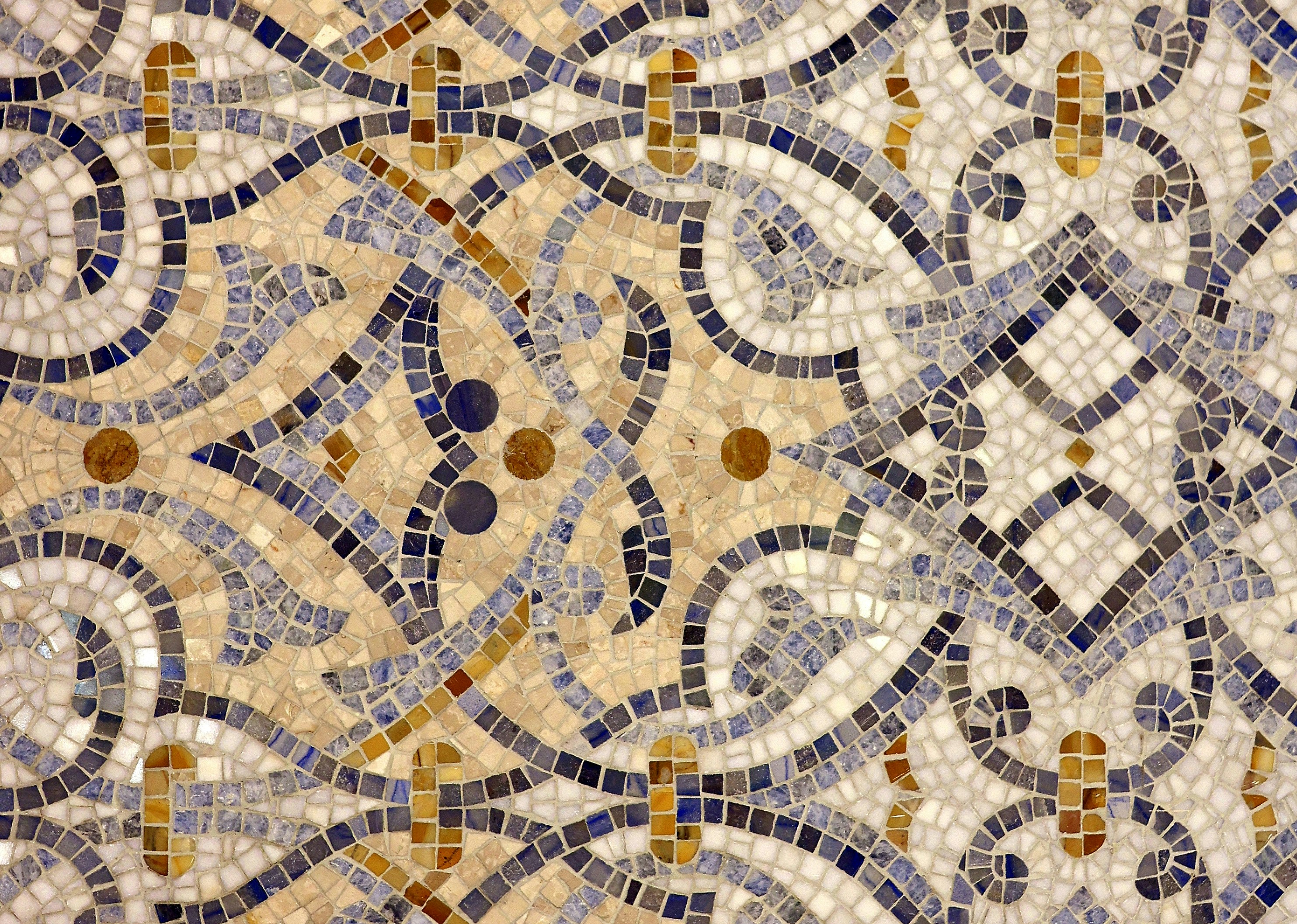Intricate mosaic tile pattern with blue, gold, and white