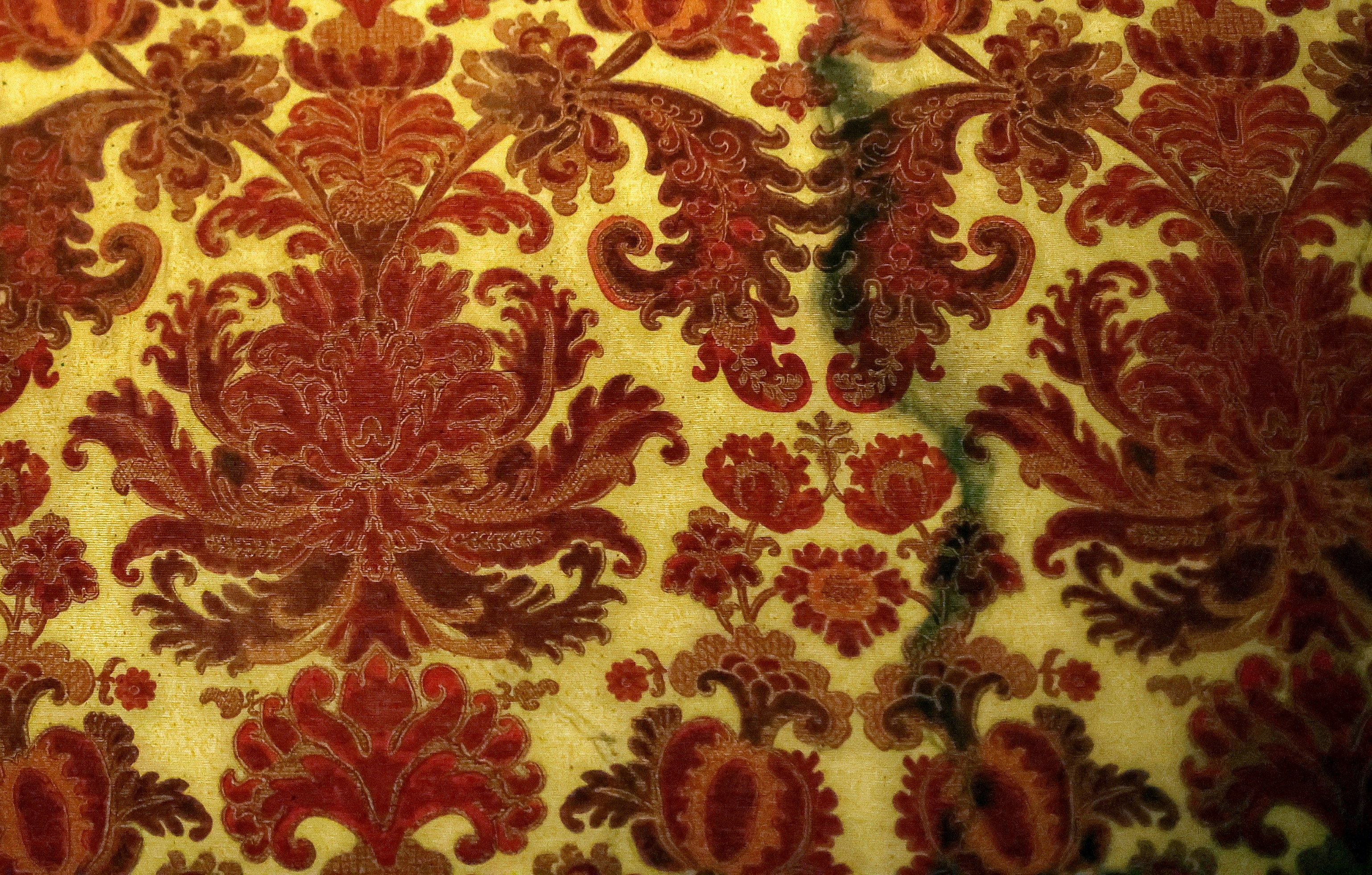 Red damask pattern on a yellow background