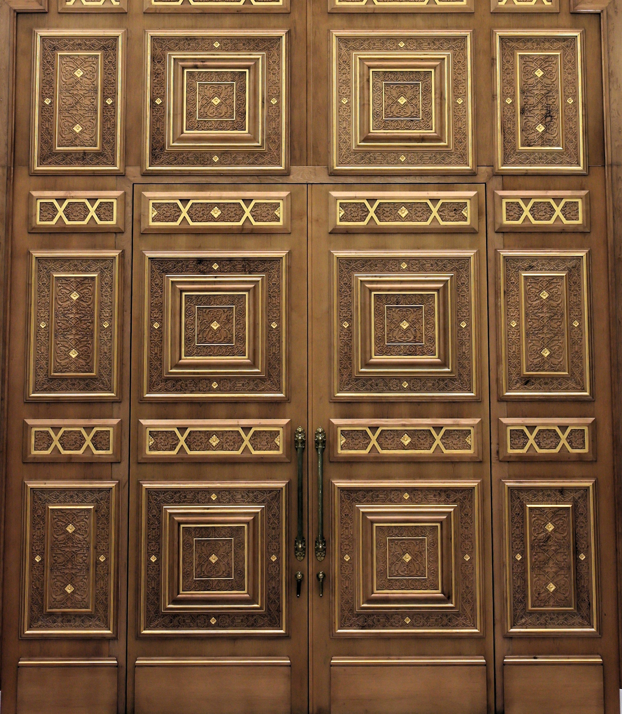 Ornate wooden doors with intricate gold geometric patterns