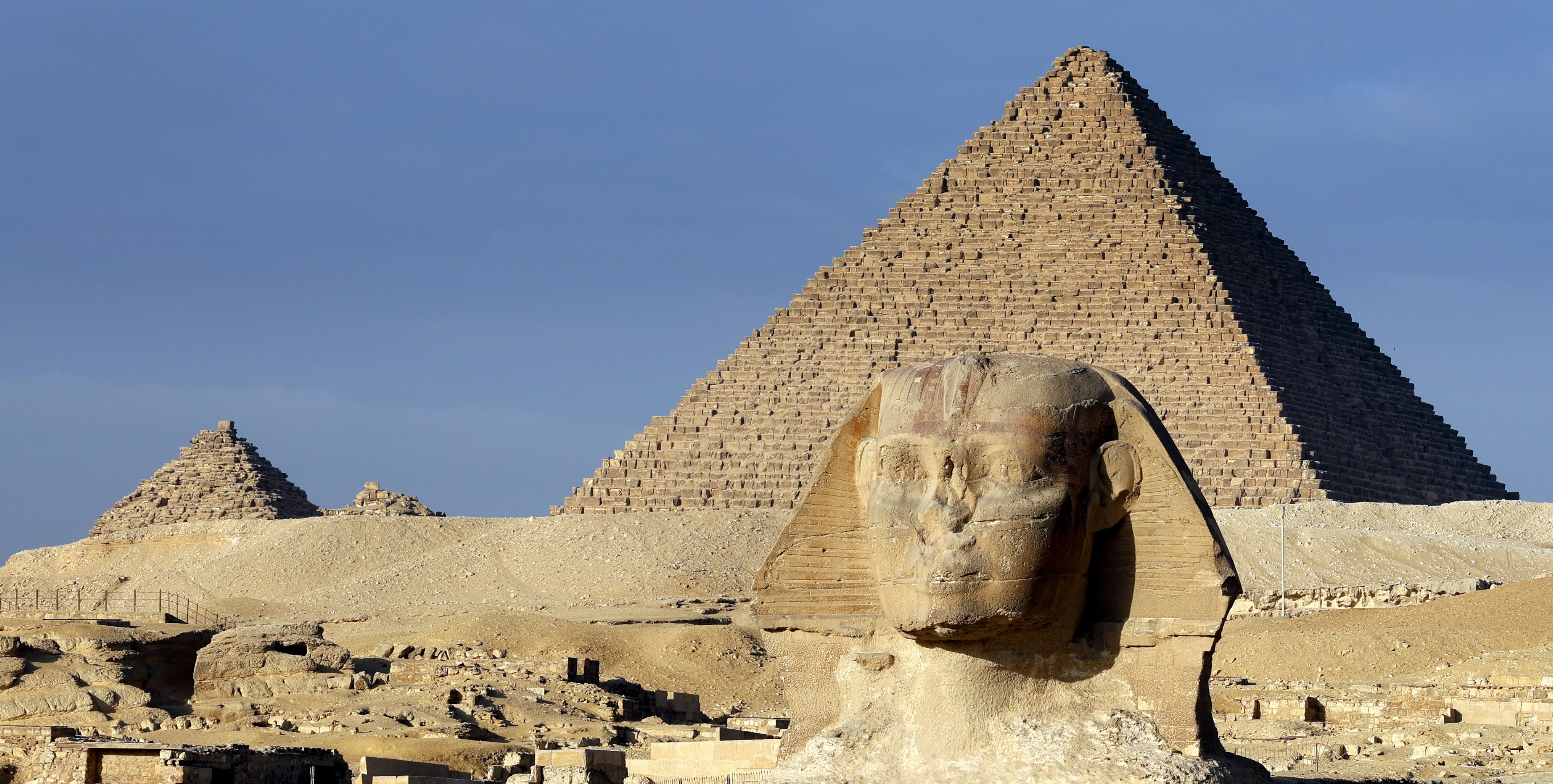 The great sphinx and pyramids under a clear blue sky