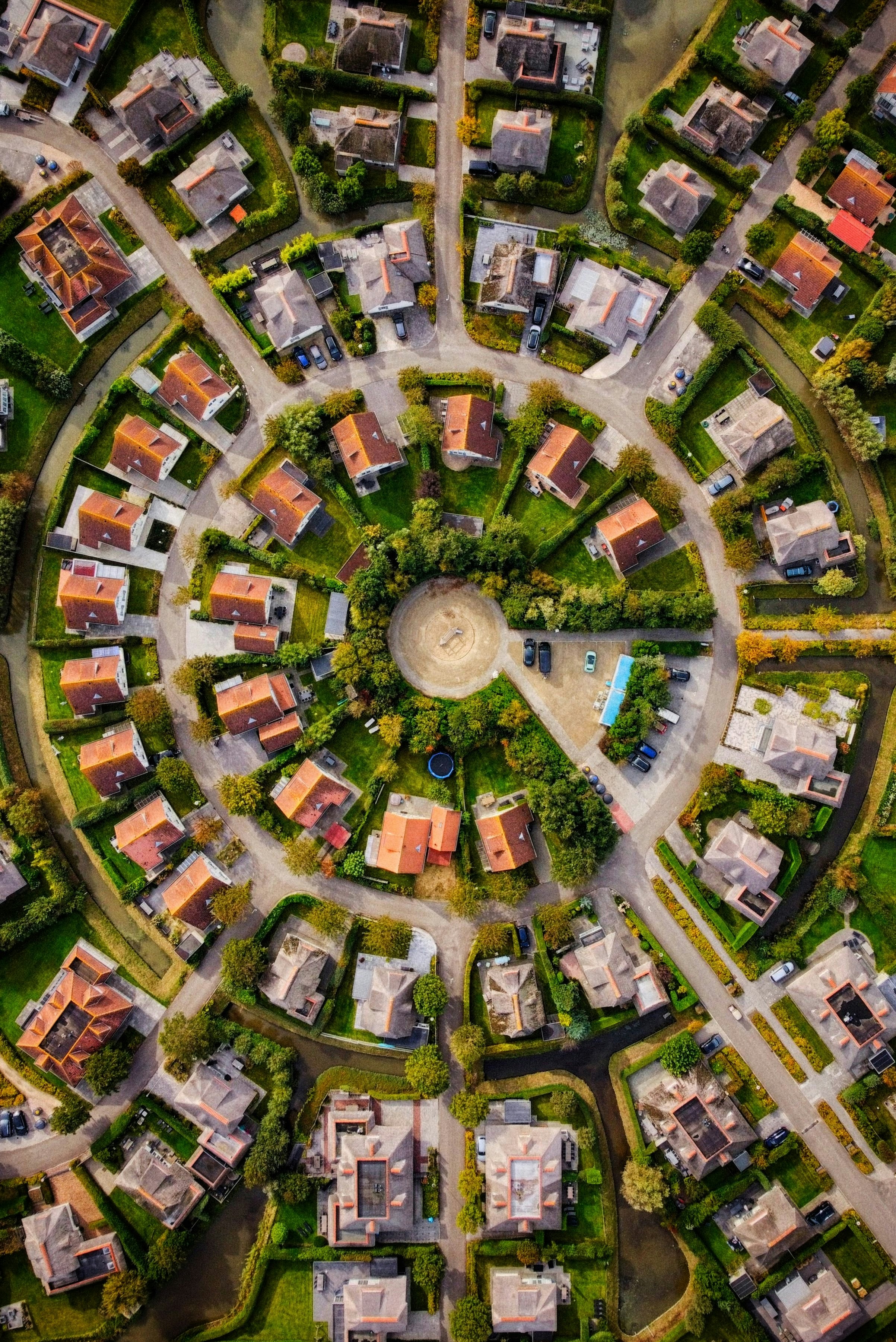 Aerial view of a circular housing development with canals