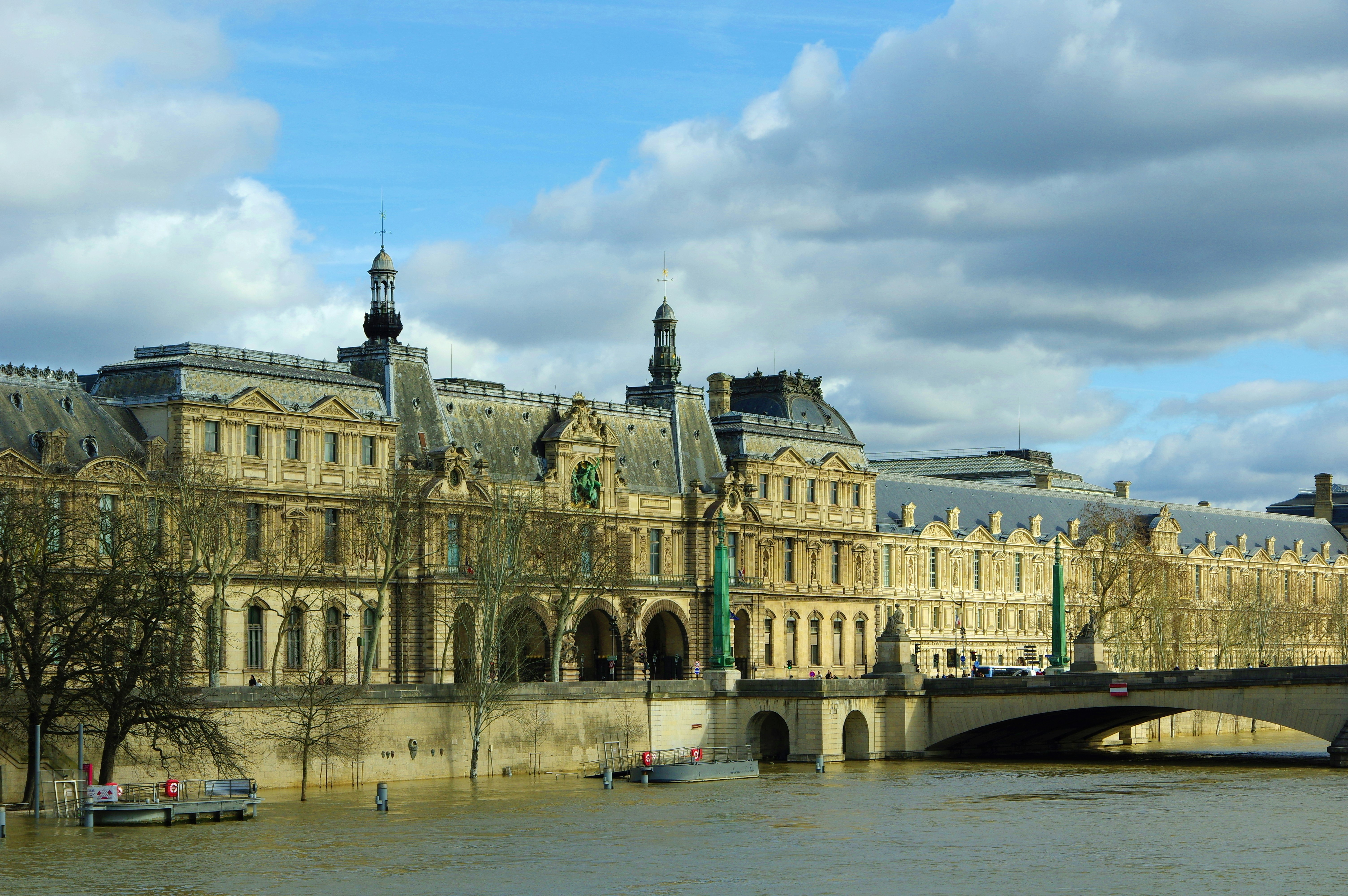 Louvre museum building on the seine river, paris