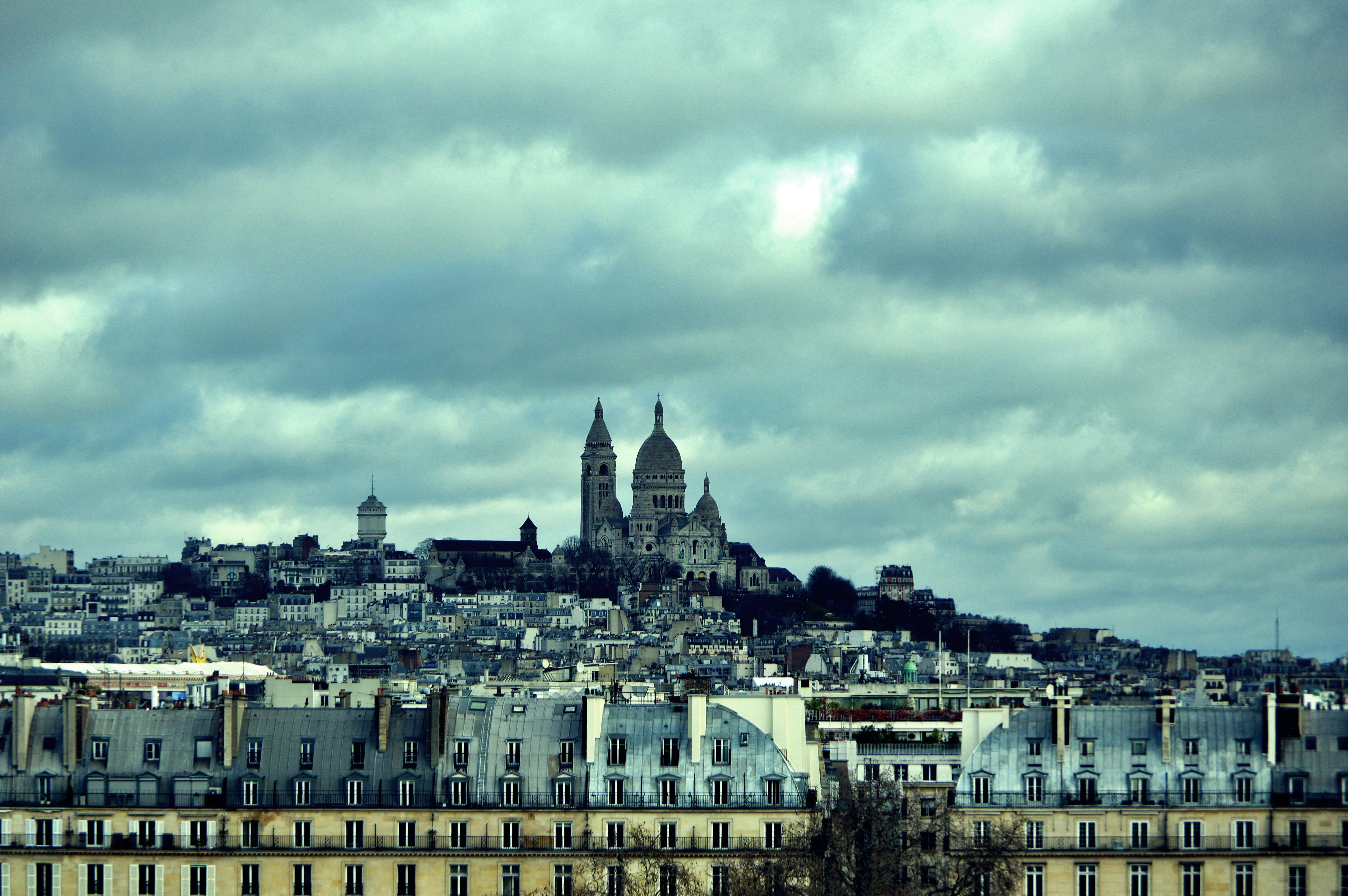 Paris skyline with sacré-cœur basilica under cloudy sky