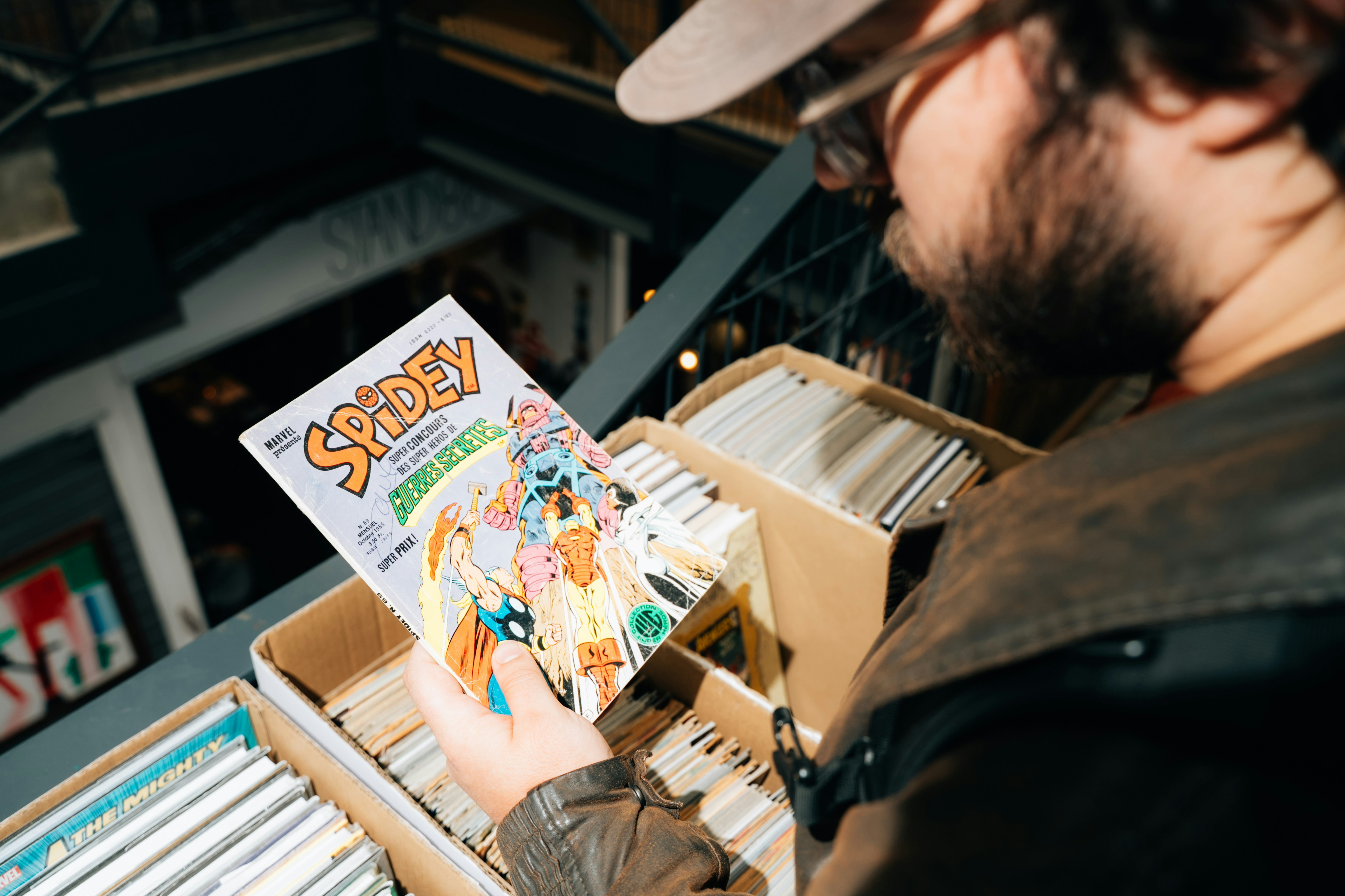 Man looking at a spidey comic book in a bin