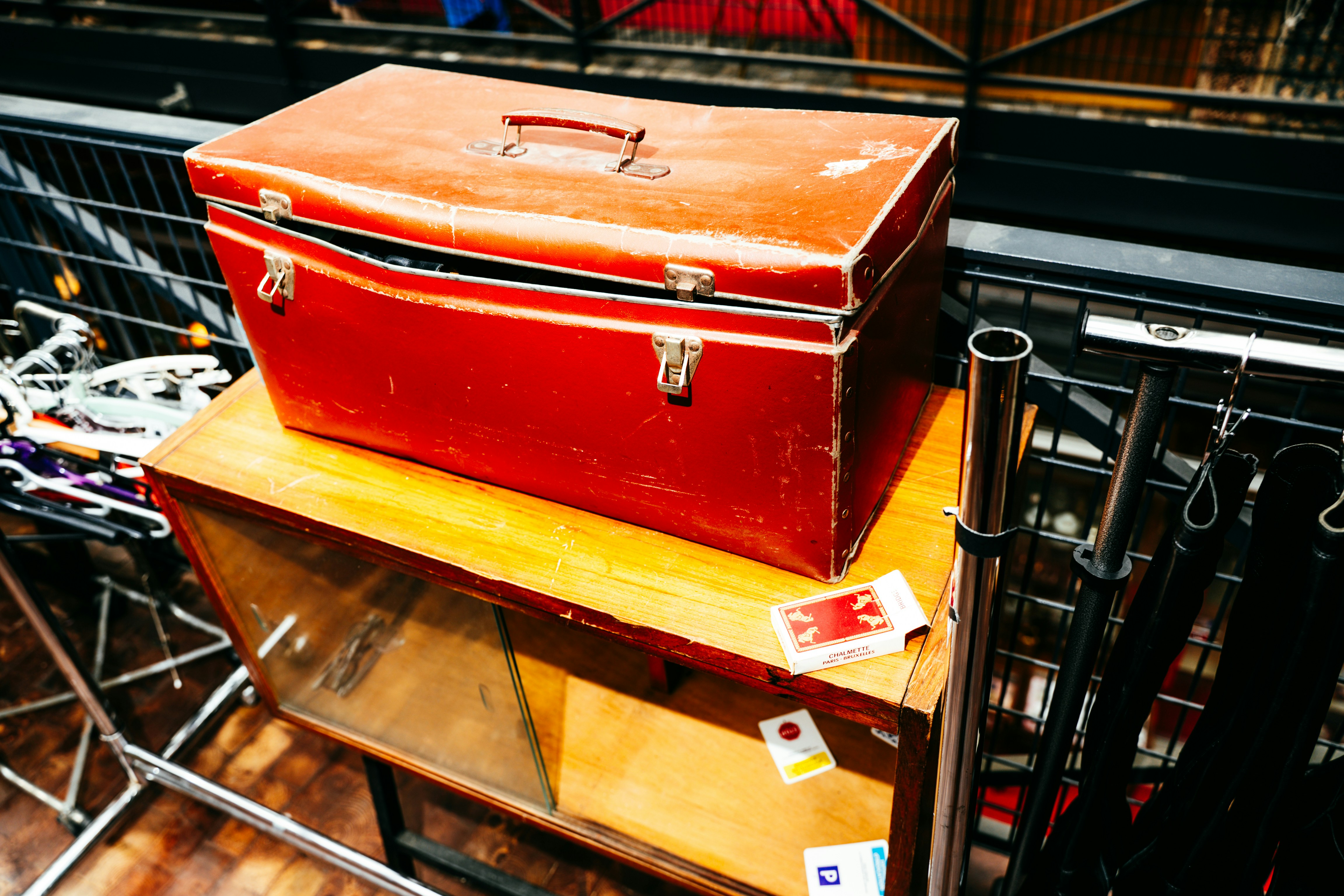 A red toolbox rests on a wooden cabinet.
