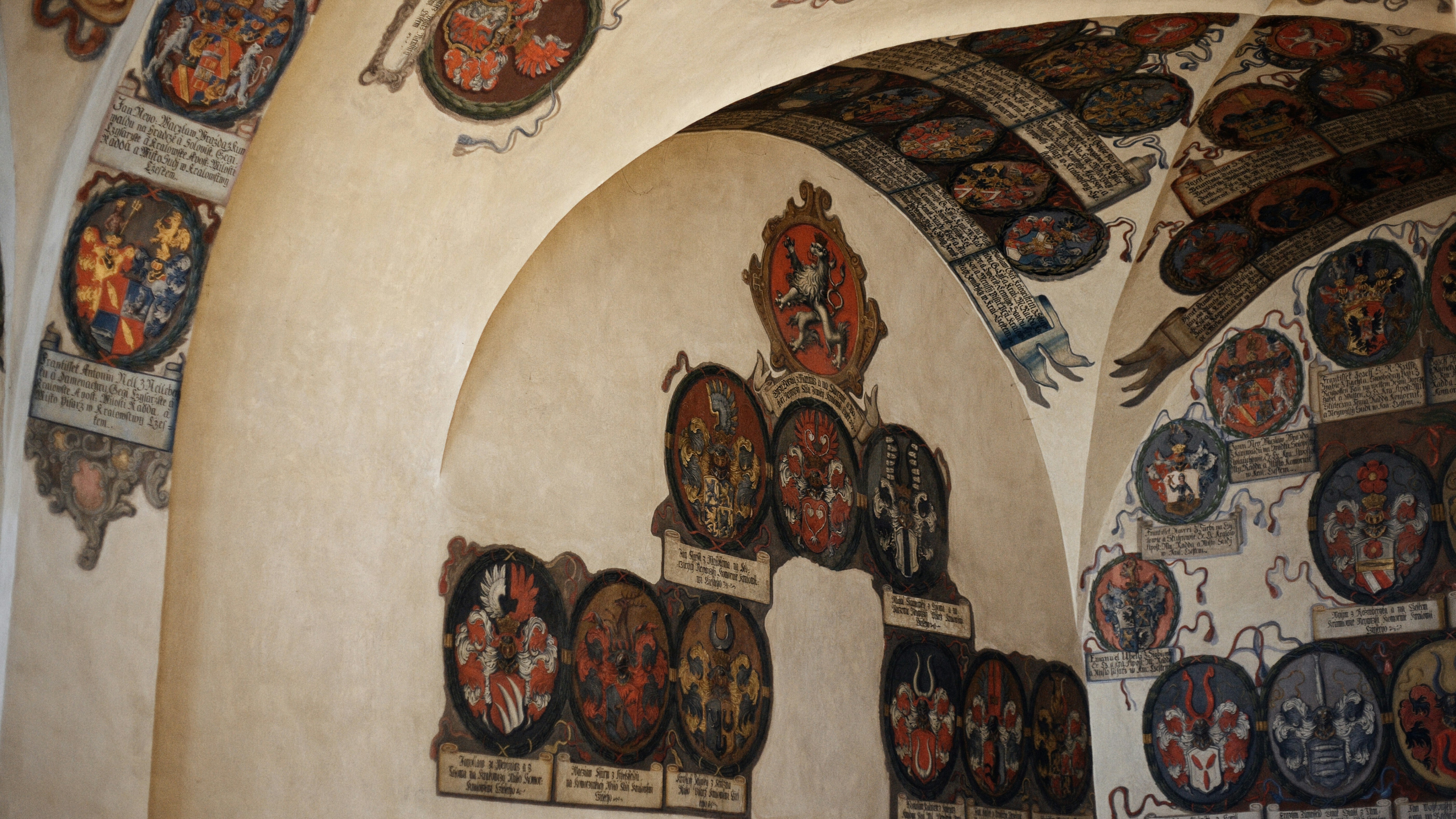 Ornate historical hall ceiling with coat of arms decorations