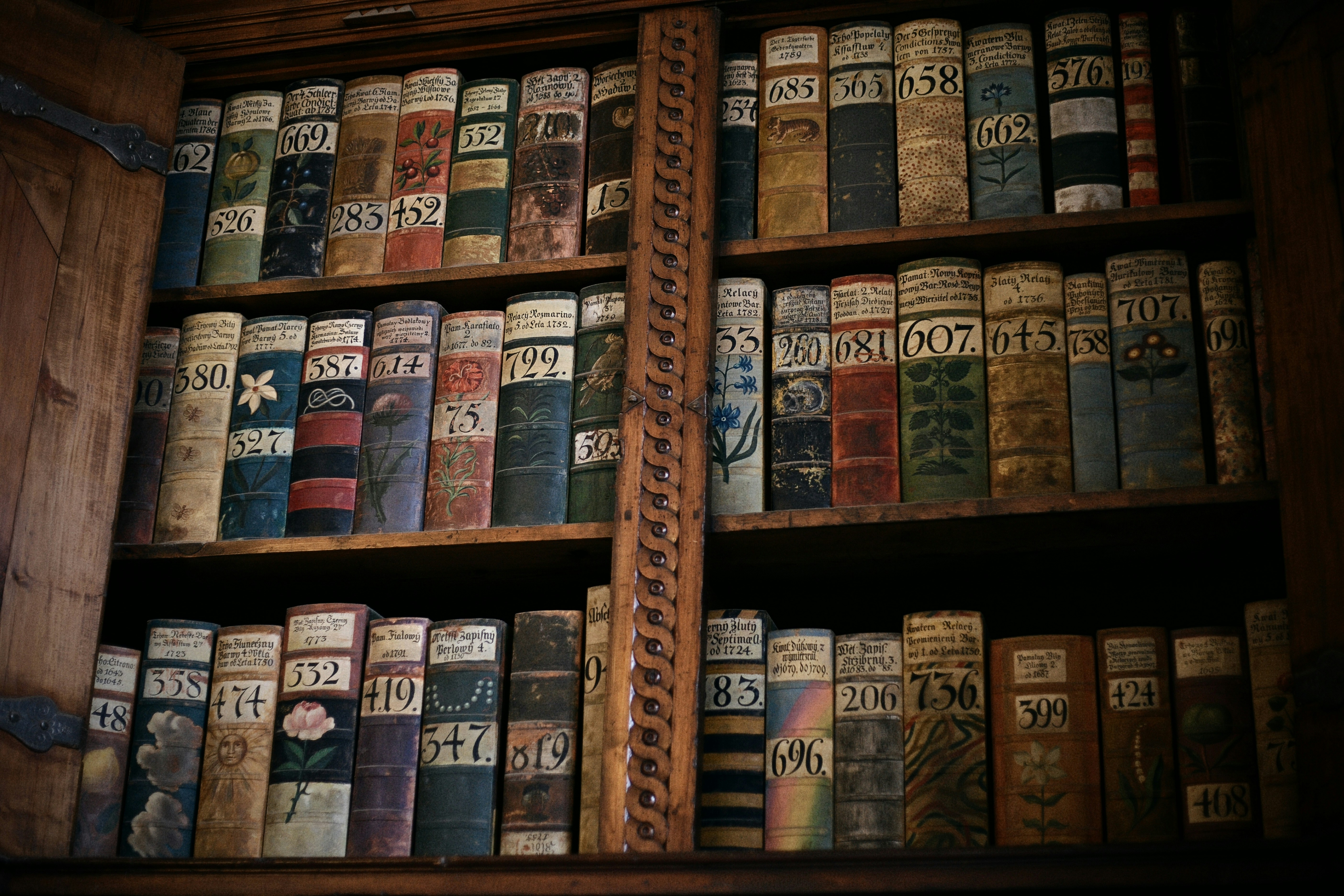 Antique books fill a wooden bookshelf