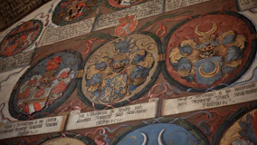 Three oval medieval coats of arms with intricate details.