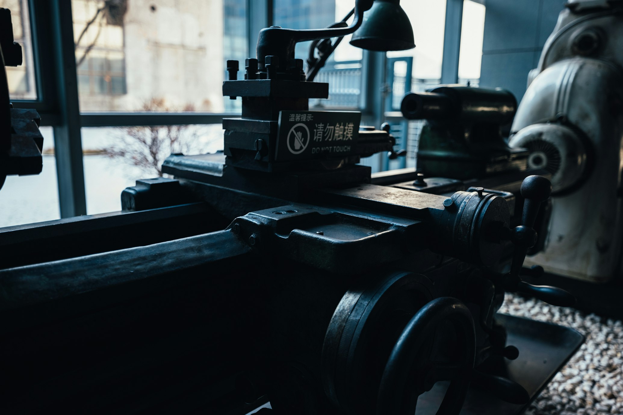 Lathe machine operator sizing a part