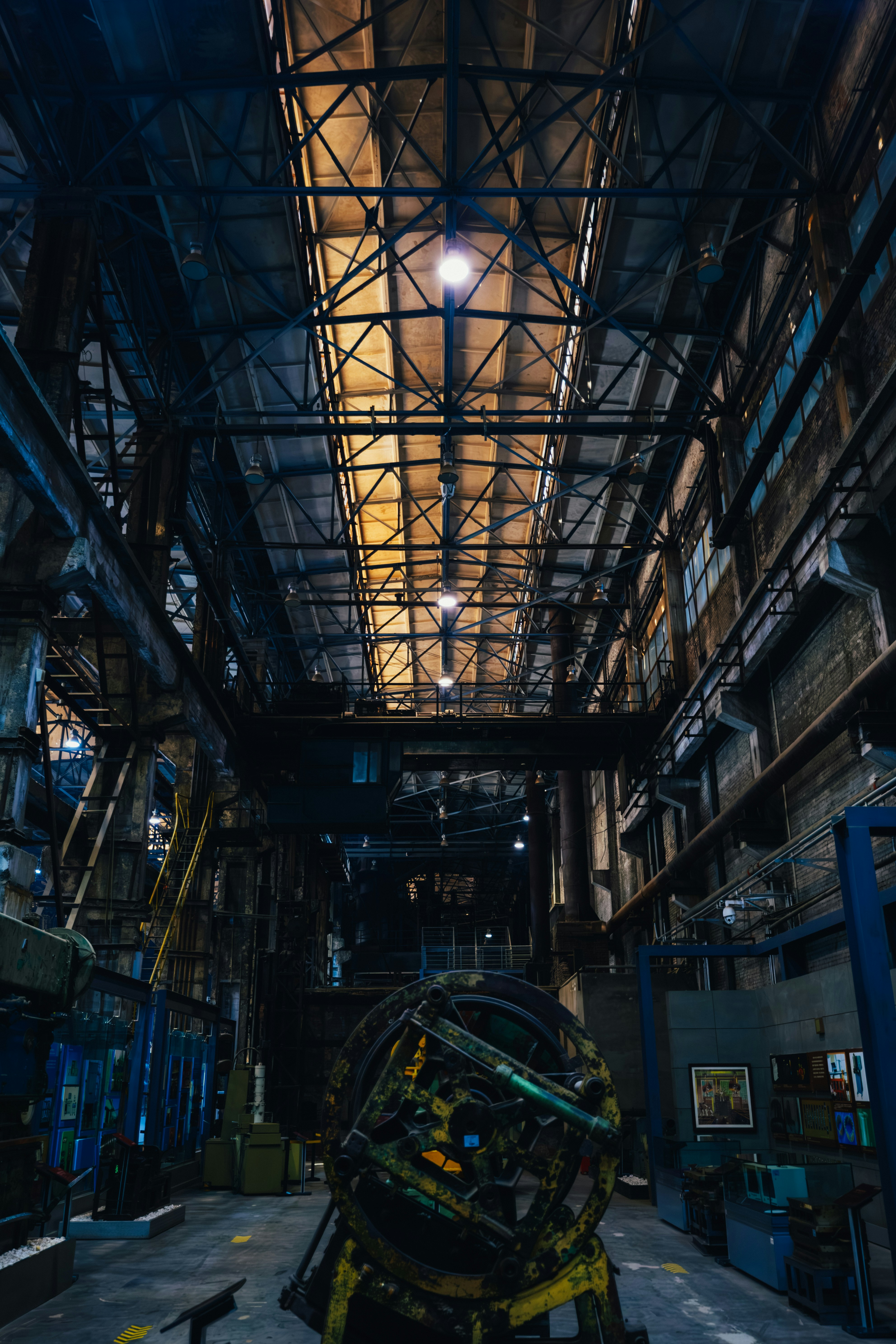 Industrial factory interior with large machinery and overhead lighting