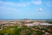 Aerial view of a sprawling city with a distant mountain.