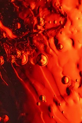 Close-up of red liquid with small bubbles.
