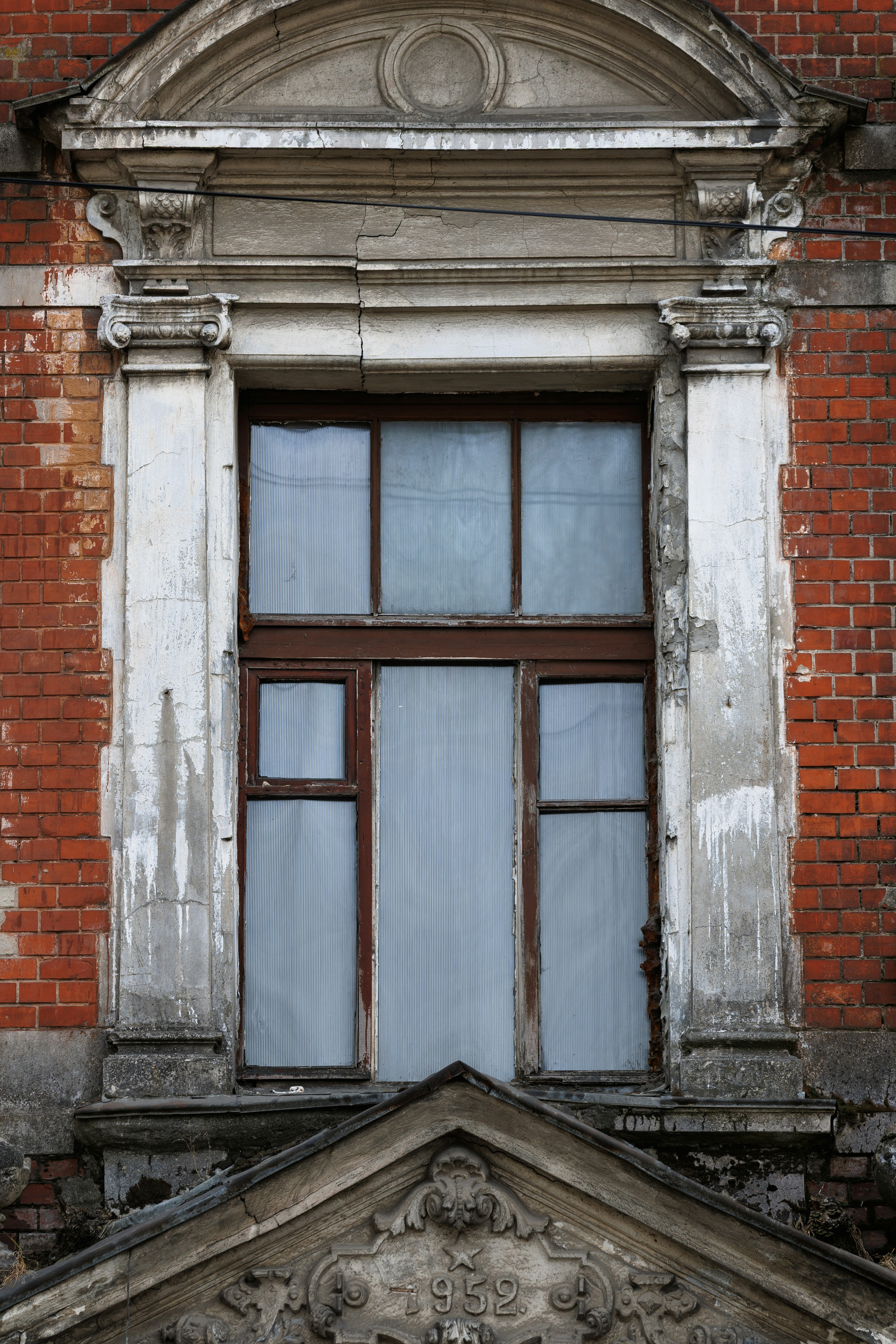 Ornate window on a weathered brick building